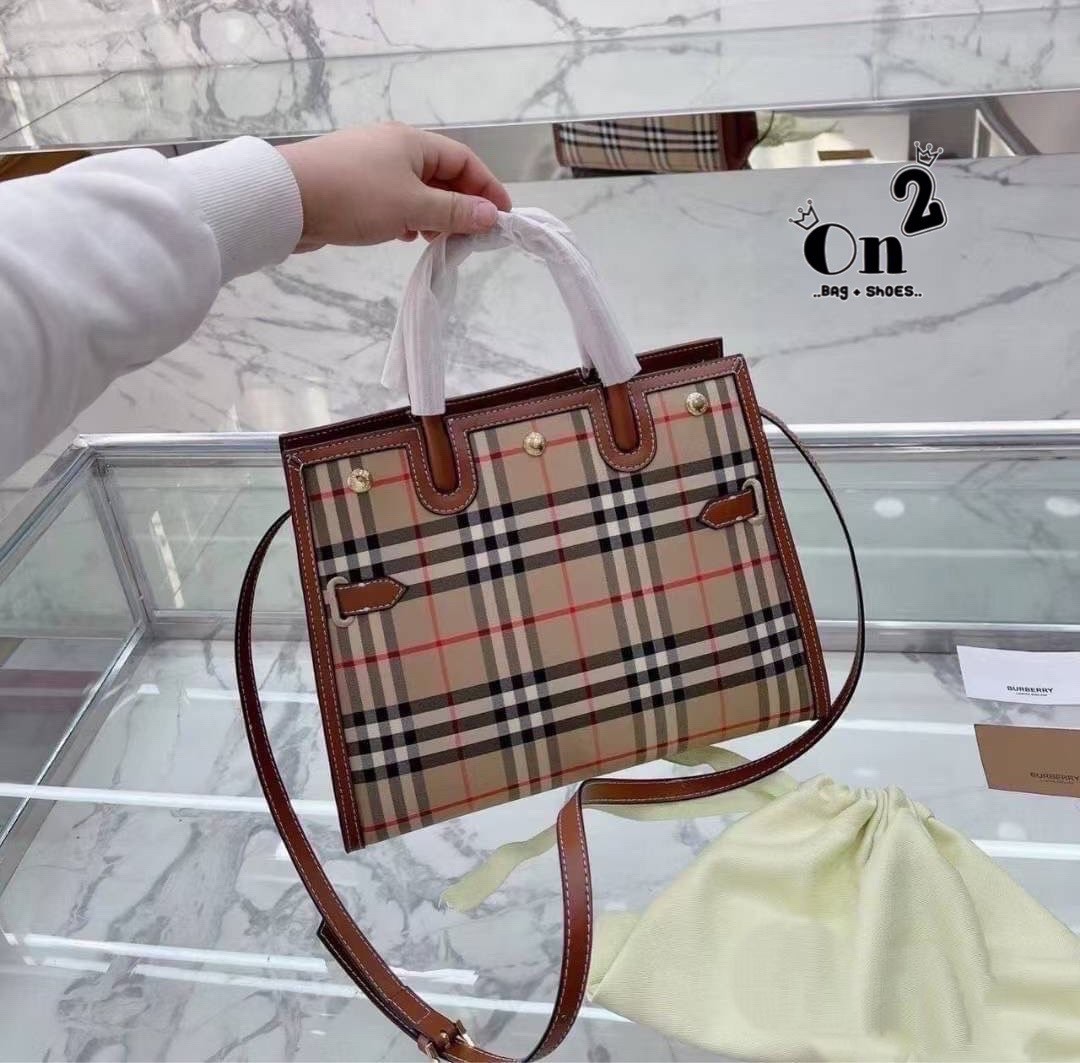 BURBERRY Women Vintage Check Two-handle Title Bag / BURBERRY Leather and Vintage Handle Bag อีกหนึ่งไอเท็มหายาก วัสดุ Leather Calfskin ลายวินเทจประดับกระดุมทองสวยหรูดีไซน์คลาสสิคคงไว้ซึ่งเอกลักษณ์แบรนด์ด้านข้างคาดด้วยสายหนังแท้ปรับทรงได้ หูจับหนังแท้แข็งแ