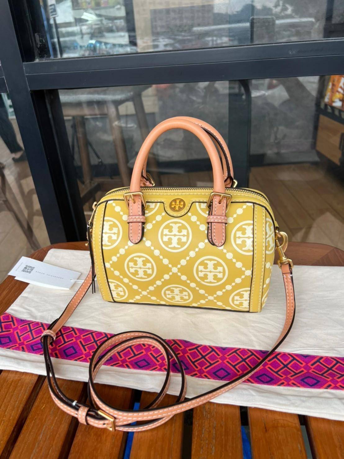 Tory Burch T-Monogram Mini Embossed Wine Bucket Bag / Tory Burch Mini Bucket กระเป๋าถือหรือสะพายไหล่ ทรงหมอนขนาดเล็ก ประดับด้วยลวดลายอันเป็นสัญลักษณ์ของแบรนด์ ถูกประดิษขึ้นด้วยความพิถีพิถันวัสดุหนังอย่างดี ด้านในบุด้วยหนังไมโครซูแอคเนื้อนุ่มทำความสะอาดง่า