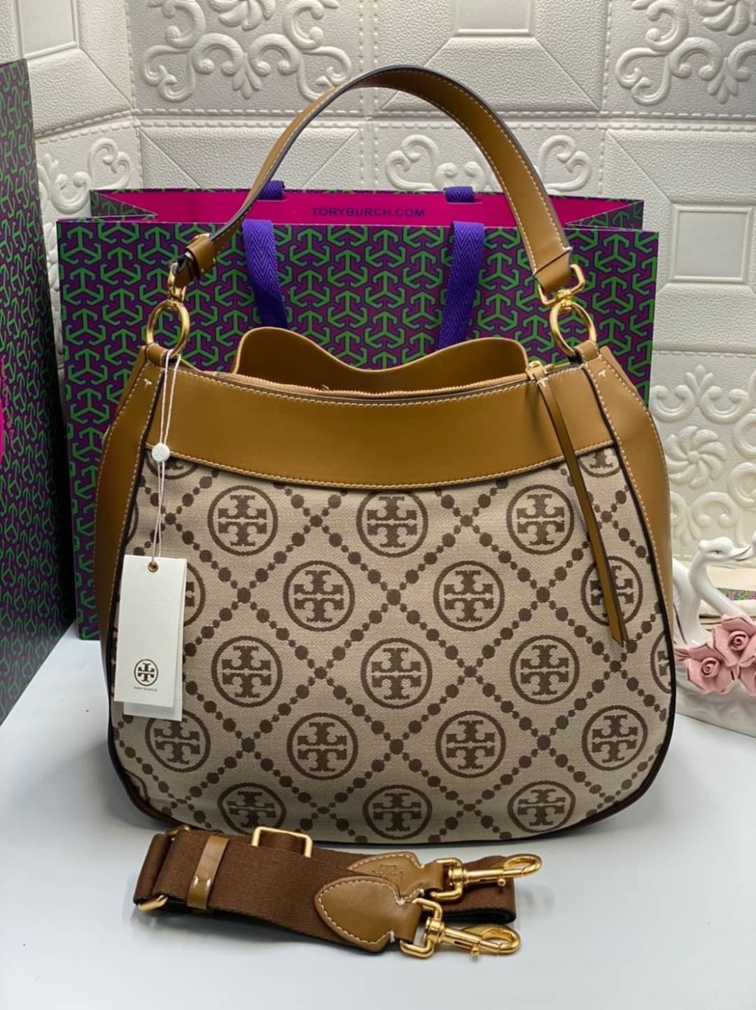 Tory burch t monogram jacquard drawstring hobo กระเป๋าถือและสะพายข้างทำจากผ้าใบ jacquard ตัดด้วยหนังแท้ อีกหนึ่งคอลเลคชั่นจาก T monogrameที่ออกแบบมาในรูปทรงกระเป๋า hobo ทรงสวย มีสไตล์เป็นทรงที่สาวๆนิยมใช้