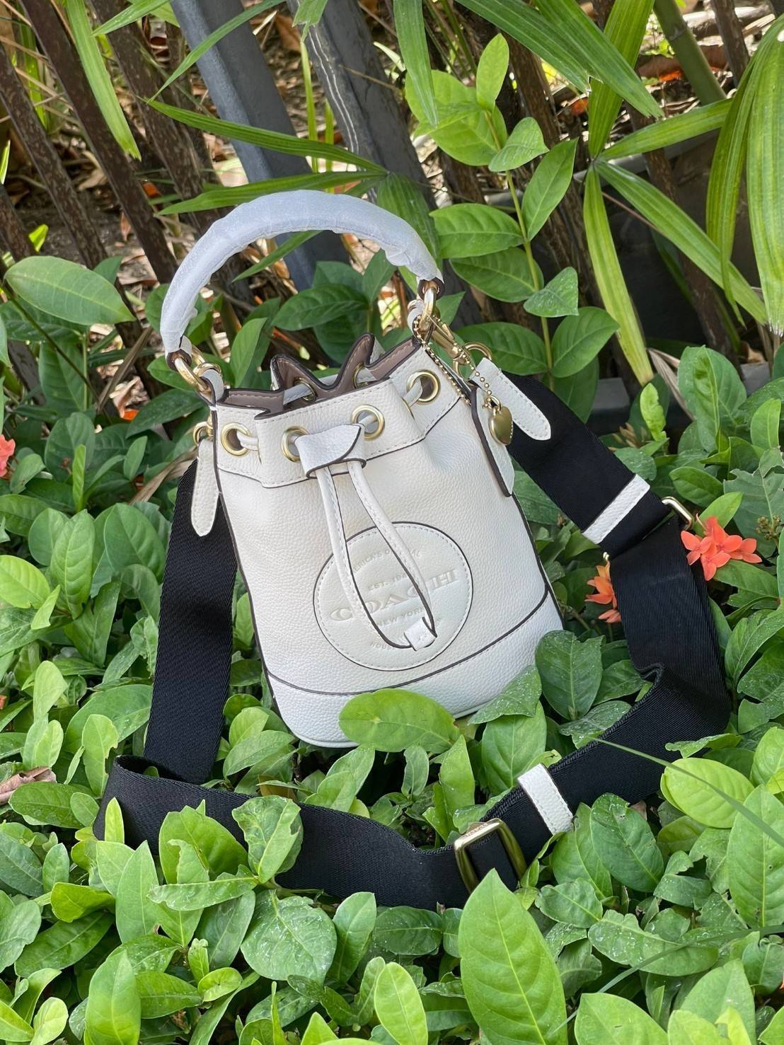 COACH DEMPSEY BUCKET BAG 15 WITH COACH PATCH AND HEART CHARM สวยงามด้วยดีไซน์ทรงตะกร้าแบบมินิมอลแสนน่ารัก ดีเทลสะดุดตา รูปทรงจดจำง่าย ถือแบบชิคๆ หรือยิ่งไปกว่านั้น สายสะพายของกระเป๋าก็สามารถถอดออกเพื่อเปลี่ยนรูปแบบการสะพายได้ทั้งแบบสะพายไหล่และสะพายคาดลำต