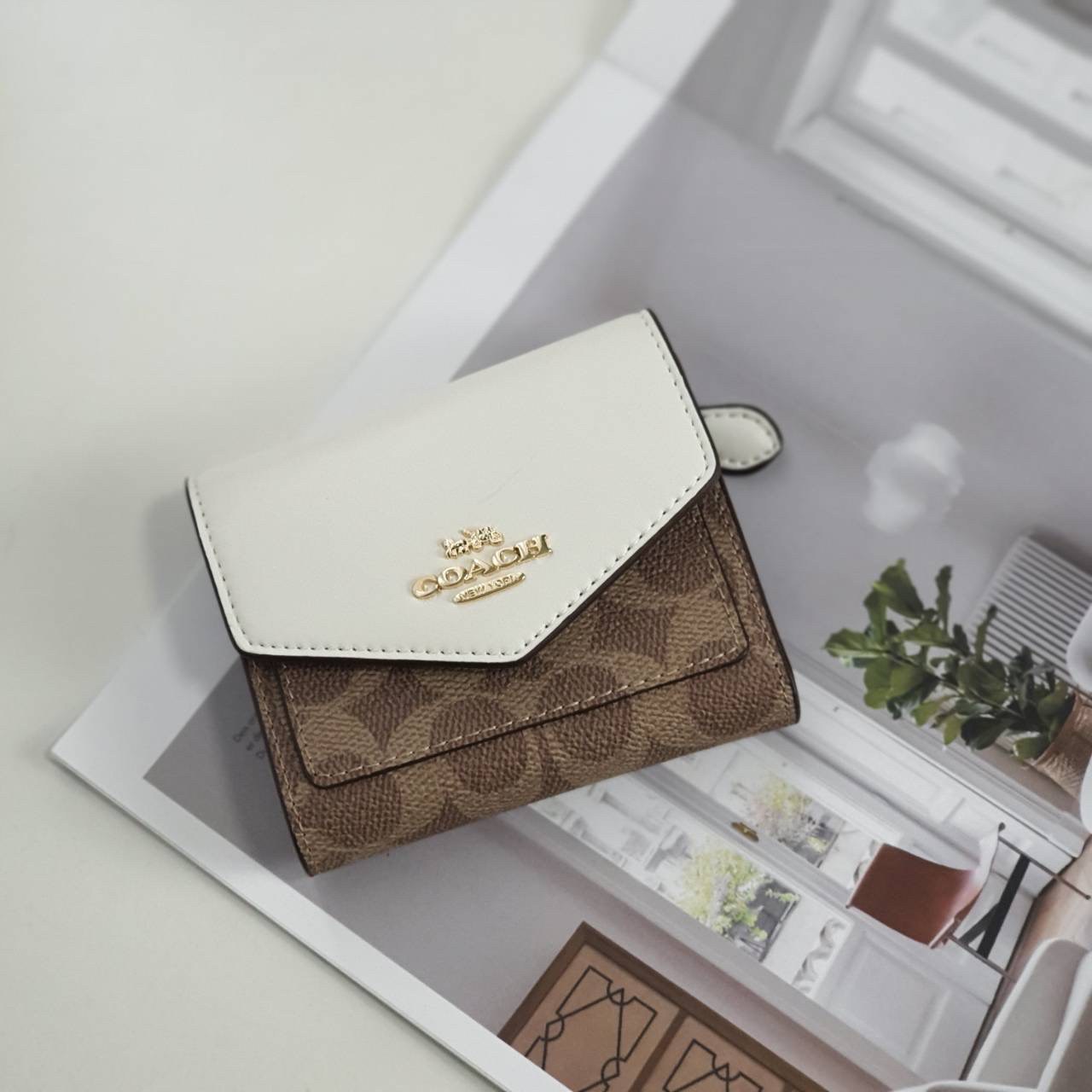 COACH SMALL WALLET IN SIGNATURE CANVAS กระเป๋าสตางค์ใบสั้น แบบพับสองตอน หน้าจดหมาย เปิดปิดด้วยกระดุมปั้มแบรนด์ ด้านในมีช่องใส่บัตรหลายช่อง และช่องใส่ธนบัตร ด้านหลังมีช่องซิปเหรียญอีกหนึ่งช่อง น้ำหนักเบา พกพาสะดวก มีให้เลือกหลายสี ห้ามพลาดค่ะ!