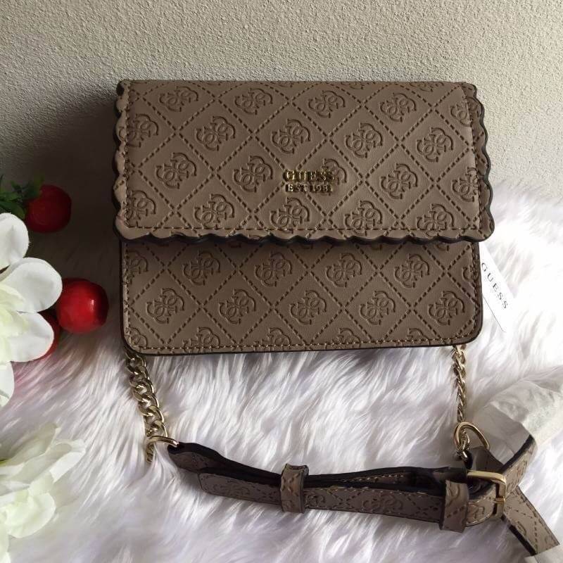 Guess Rayna Logo-Embossed Mini Crossbody กระเป๋าสะพายข้างทรง ครอสบอดี้ วัสดุหนัง pu ปั้มลาย Signature รอบใบรวมถึงสายยาว สวยตั้งอยู่ทรง ด้านหน้ามีโลโก้แบรนด์ เปิดปิดด้วยฝาปิดกระดุมแม่เหล็กซับในลายแบรนด์ มีช่องใส่บัตร ใส่มือถือ ของใช้จุกจิกได้เยอะ น้ำหนักเบ