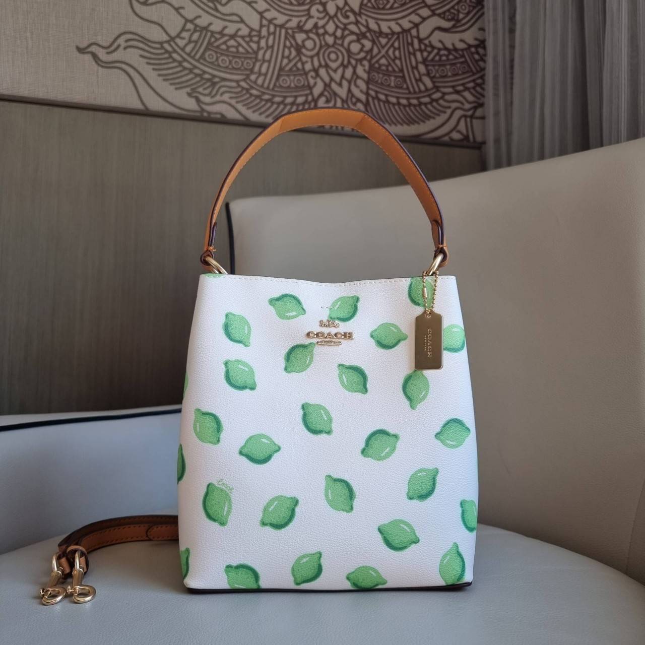 OUTTLET 】COACH 1625 SMALL TOWN BUCKET BAG WITH LIME PRINT ต้อนรับปีใหม่ด้วยความสดใส กับรุ่นยอดนิยม กระเป๋าทรงบัคเก็ตไซส์เล็ก ดีไซน์ลวดลายจี๊ดจ๊าด น่าใช้จริงจัง วัสดุหนังแคนวาสเคลือบลาย สวยคมแซ่บมากๆ เปิด-ปิดด้วยกระดุมแม่เหล็กทั้ง 2 ฝั่ง ภายในเป็นช่องโล่ง 