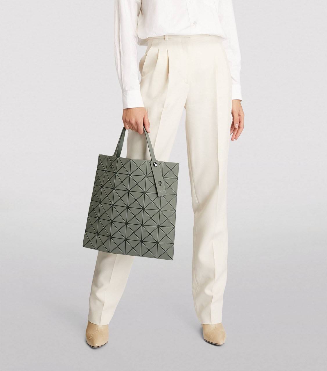 BAO BAO ISSEY MIYAKE LUCENT ONE-TONE กระเป๋าสะพายไหล่ ทรงโท้ท ใบใหญ่สวยมาก ปรับได้หลายทรงตามเอกลักษณ์เฉพาะของแบรนด์นี้ วัสดุ 100% POLYESTER PARTLY: SYMYHETIC LEATHER ด้านในใส่ของได้เยอะมาก ใส่ไอแพด สมุดโน้ตได้สบายเลย วัยทำงานหรือวัยนักศึกษา อย่างน้อยต้องม