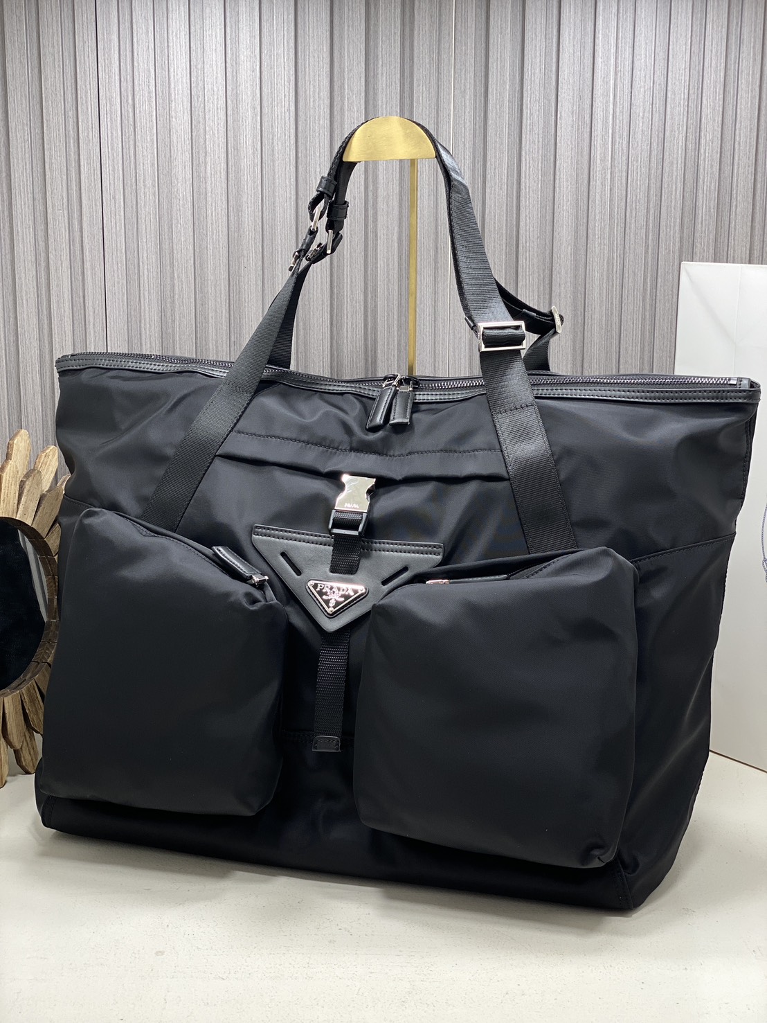 ORI หนังแท้ | Prada Re-Nylon and leather travel bag กระเป๋าถือใบใหญ่ทรงโท้ท งานผ้าไนลอนรูปทรงเรขาคณิตเรียบหรู สถาปัตยกรรมและเส้นสาย ผสมผสานรูปทรงและวัสดุที่ตัดกันอย่างลงตัว