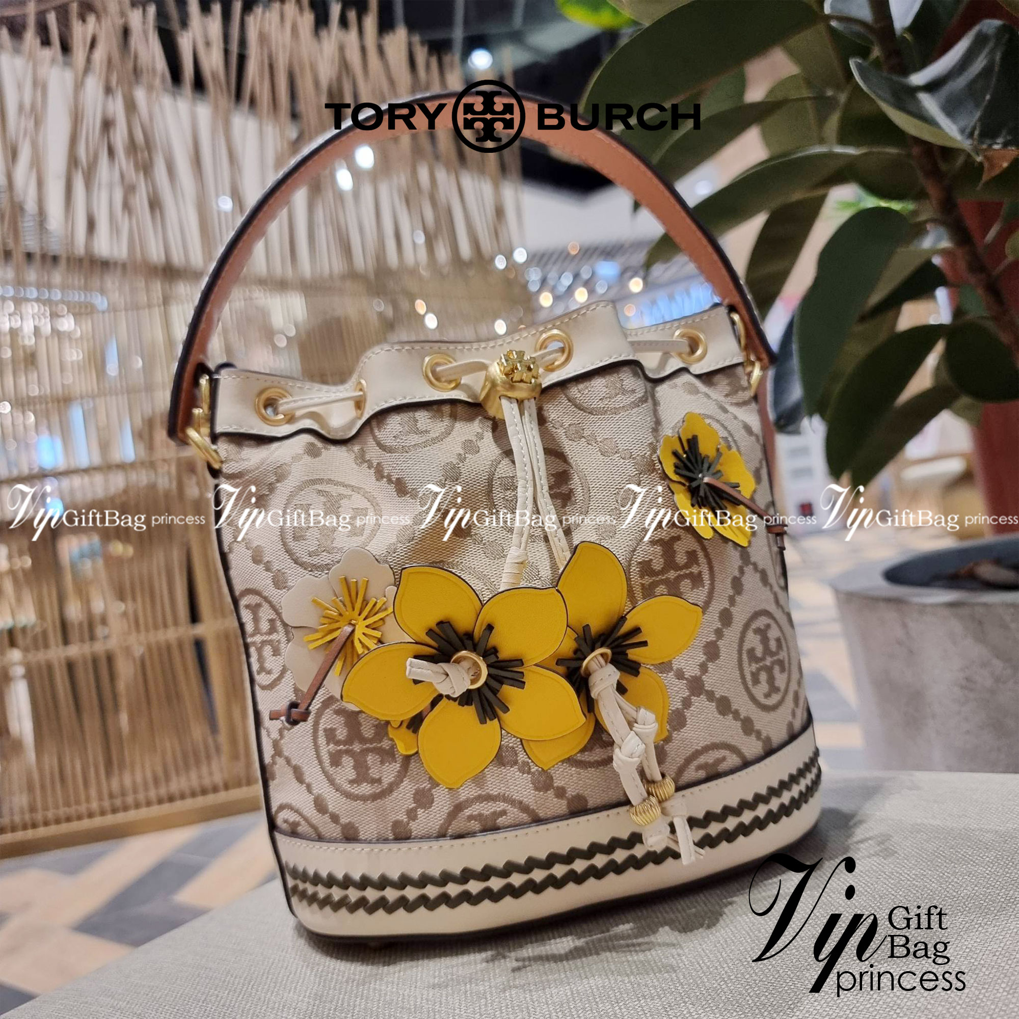 TORY BURCH T MONOGRAM FLORAL BUCKET BAG คอลเลคชั่นใหม่ พร้อมเสิร์ฟความสวยให้ถึงบ้าน!! กระเป๋าบัคเก็ตทรงยอดนิยม ดีไซน์ใหม่ล่าสุด สไตล์งานคราฟ มีลูกเล่นประดับดอกไม้กับตัวกระเป๋า และตัวรูดสาย วัสดุผ้า jacquard ตัดสลับหนังแท้ หูจับและขอบกระเป๋าตกแต่งลายสานสวย