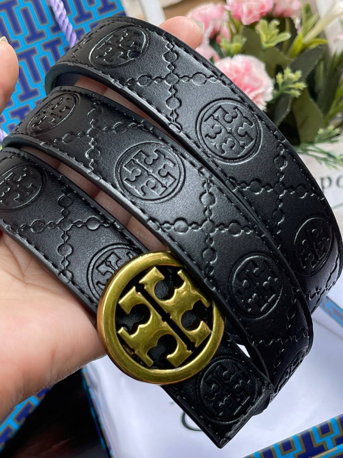 Tory burch Midnight with Tag Logo Monogram Embossed Leather Belt เป็นเข็มขัดที่ตอบโจทย์ของคุณได้อย่างลงตัวทุกสไตล์การแต่งตัว ไม่ว่าจะใส่คู่กับเดรสหรือกางเกงยีนส์ก็ดูดีทีเดียว เพราะหัวเข็มขัดโดดเด่นด้วยดีไซน์ทรงกลมรูป Double T ที่เป็นสัญลักษณ์ประจำแบรนด์ ส
