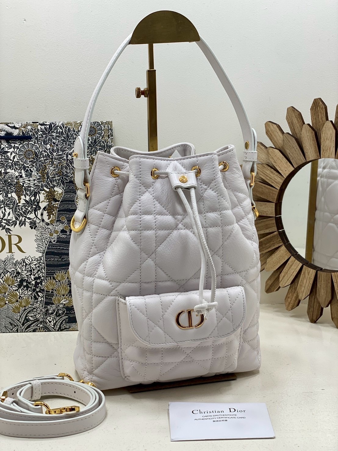ORI หนังแท้ | Small Dior Caro bucket bag กระเป๋าทรงบักเก็ต รุ่นใหม่ประจำ Fall 2025 โดดเด่นด้วยดีไซน์ที่ทันสมัยและสง่างาม ได้รับการรังสรรค์ขึ้นจากหนังแกะสีดำเดินด้ายลาย Macrocannage พร้อมกับช่องเก็บของขนาดใหญ่แบบเชือกรูดปิด