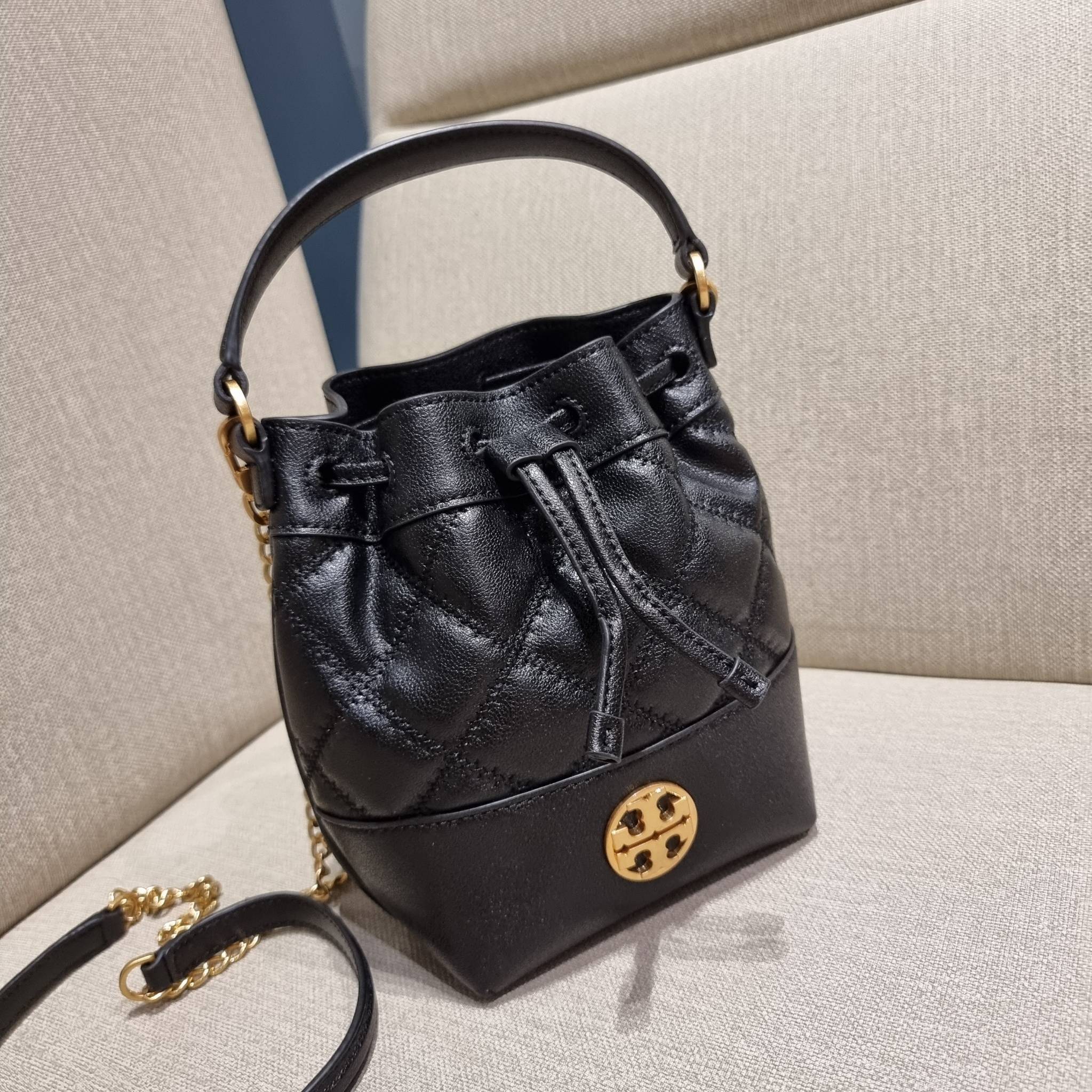 TORY BURCH WILLA MINI BUCKET BAG NEW ARRIVAL สุดปัง กระเป๋าสะพายทรงบัคเก็ต สวยผู้ดี โดดเด่นด้วยโลโก้สีทองดูหรู อัพลุคผู้ดี๊ผู้ดี วัสดุหนังแท้ ดีไซน์บุนวม เส้นคมดีเทลหรู เปิด-ปิดหนังรูดปากกระเป๋า มีหูหิ้วในตัว คล้องแขนเก๋ๆ ภายในเป็นช่องโล่ง มีช่องย่อย ใส่ข