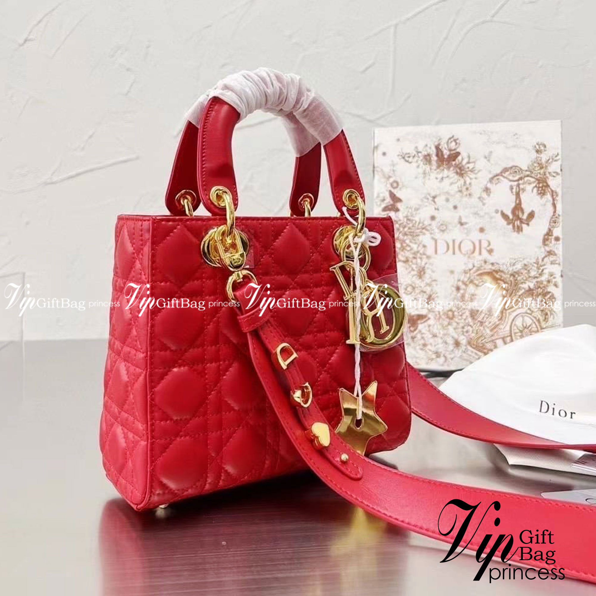 DIOR Lady / Small Lady Dior Bag Cannage Lambskin กระเป๋าสุดไอคอนิก รูปทรงสีเหลียม ขนาดกระทัดรัด ตั้งอยู่ทรง ฐานกระเป๋าแข็งแรง มีหมุดรองฐาน ดีไซน์เอกลักษณ์เฉพาะตัว ด้านหน้าตกแต่งด้วยตัวอักษร D.I.R ห้อยเป็นพวงกุญแจ จะถือหรือสะพายไหล่ก็ดูดีมากๆ ค่ะ
