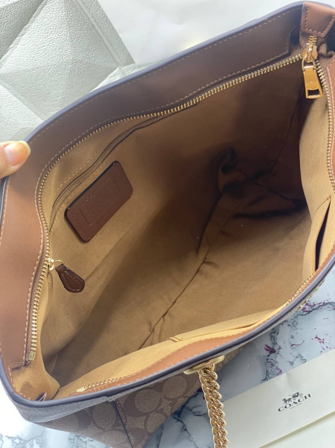 COACH Tote in Signature Canvas Bag กระเป๋าสะพายทรงช้อปปิ้ง สายกระเป๋าเป็นหนังสลับโซ่ทองสวยงาม เพิ่มความหรูหรา ภายในโล่งกว้างใส่ของได้เยอะมาก วัสดุ Canvas เคลือบลายซิกเนเจอร์และหนัง พร้อมซิปกลางเก็บของได้มิดชิดเลยค่ะ มี 3 สี น้ำตาล ดำ ขาว