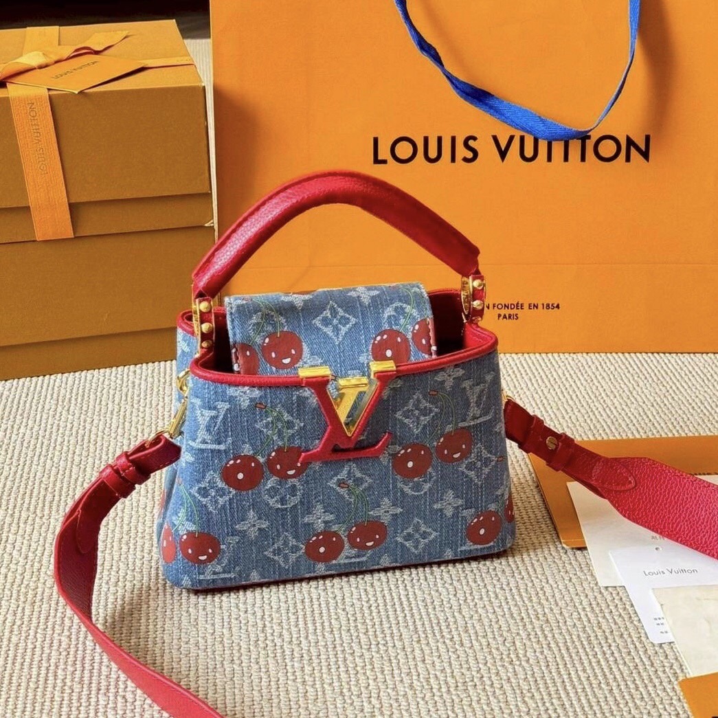 LV Capucines Monogram cherry denim กระเป๋าถือสุดหรูรูปทรงสวยคลาสสิกมาพร้อมหูจับในตัว สวยคมสะกดทุกสายตา ที่สุดของความสวยในราคาเบาๆ โดดเด่นมีชีวิตชีวา ด้วยเดนิมวินเทจปักลายเชอร์รี่สีสันสดใสสะดุดตาสะท้อนสไตล์ไอคอนิก