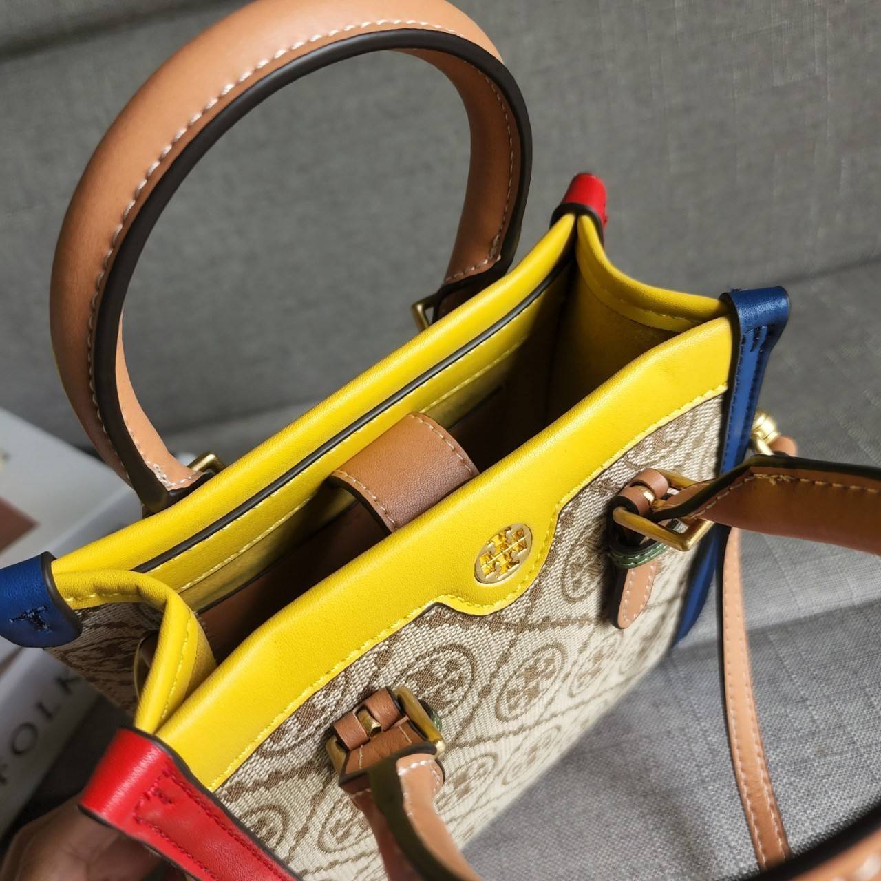 TORY BURCH T MONOGRAM COLORBlOCK JACQUARD MINI TOTE คอลเลคชั่นใหม่ล่าสุด ครอบครองก่อนใคร ไอเท็มยุคนี้รุ่นที่ควรมีติดตู้คะสาวๆ วัสดุ jacquard สลับหนังแท้ หูจับ มาพร้อมสายสะพายข้างหนังแท้ ปรับระดับได้ สายสามารถถอดออกได้ ภายในเป็นช่องโล่ง ใส่มือถือได้ กระเป๋