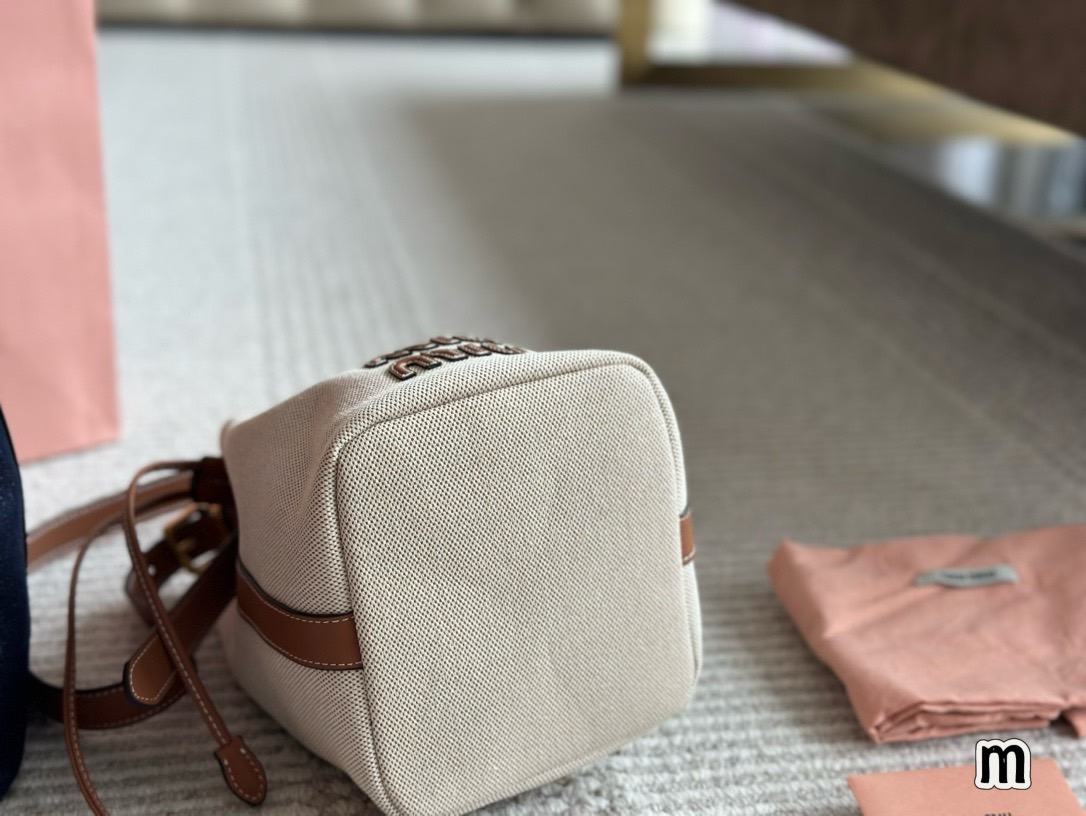MIU MIU Canvas and leather bucket bag / MIU MIU Bucket Bag กระเป๋าทรงบัคเก็ต ผ้าแคนวาสอย่างดีตกแต่งโลโก้เพิ่มสัมผัสอันเป็นเอกลักษณ์