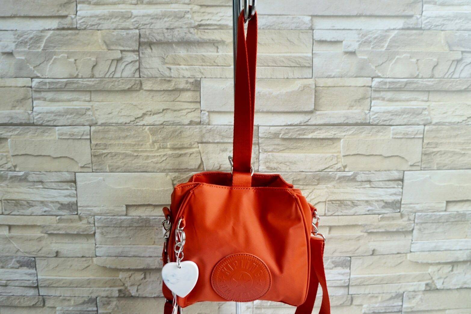 NEW ARRIVAL! Kipling 2Way Mini Bucket Bag กระเป๋าถือหรือสะพาย 2Way ขนาดมินิรุ่นใหม่ทรงขนมจีบวัสดุ Nylon & Polyester 100% น้ำหนักเบา พวงกุญแจรูปหัวใจปั้มแบรนด์คอลเลคชั่นพิเศษถอดแยกใช้ได้ เปิดปิดสไตล์ Drawstring มีกระดุมคาดกลาง ภายในมีโลโก้ ช่องซิป ช่องใส่ข