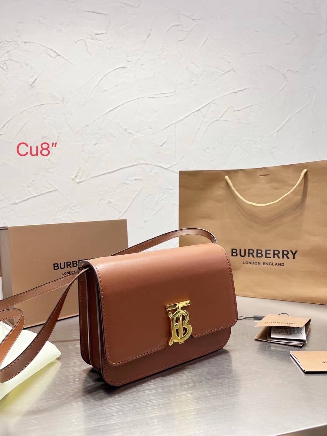 BURBERRY Leather Medium TB Bag / BURBERRY FRAGRANCES CROSSBODY BAG กระเป๋าสะพายหนังเรียบสวยอยู่ทรงดีไซน์ยอดนิยมประดับโลโก้แบรนด์ทองด้านหน้า เปิดปิดด้วยฝาปิดสัญลักษณ์ตัวB ภายในมีช่องแบ่งเป็นสัดส่วนมีช่องซิปหัวซิปแบรนด์