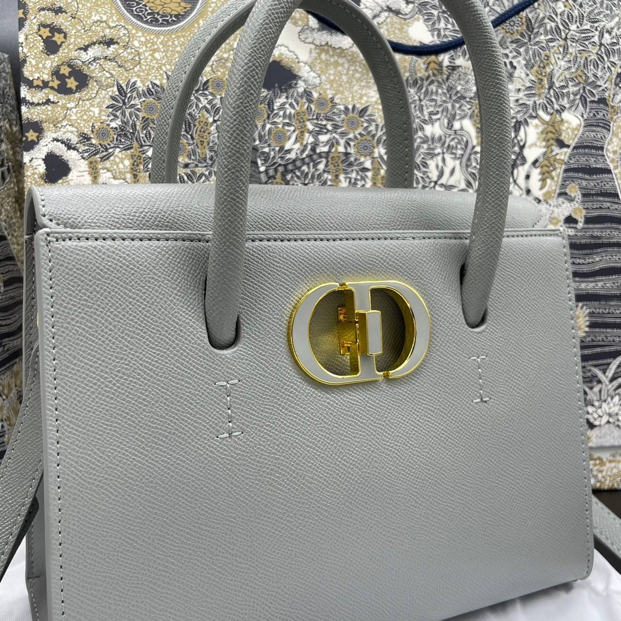 หนังแท้ DIOR Medium ST Honore Tote Collection Fall/Winter 2020-2021 มาในรูปแบบกระเป๋าทรงสี่เหลี่ยมที่ได้มาตรฐาน ทำจากหนังลูกวัว (Calfskin) ลายเกรน ซึ่งสื่อถึงความหรูหราได้อย่างลงตัว ตัวด้ามจับ มีการเย็บเข้าด้านในของกระเป๋าเพื่อเพิ่มความแข็งแรงทนทาน ด้านหน