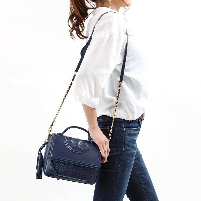 Tory Burch Fleming Satchel Bag รุ่น 45147 สี Royal Navy กระเป๋าสะพาย Crossbody ทรงสวย ดีไซน์เก๋ สุดคลาสสิค เพิ่มดีเทลโลโก้แบรนด์บนฝากระเป๋าอัพลุคให้ดูเท่ห์ และ พู่หนังถอดได้ วัสดุหนังแท้ สัมผัสนุ่มมือ หนังสวย น้ำหนักเบา ตั้งอยู่ทรง เปิดปิดด้วยกระดุมแม่เหล