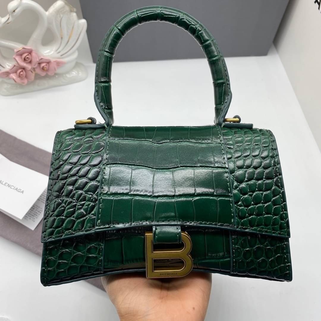 หนังแท้ BALENCIAGA HOURGLASS TOP HANDLE XS Shiny crocodile embossed calfskin การสร้างสรรค์ที่มีเอกลักษณ์เฉพาะตัว หรูหรา โทนสีโดดเด่น วัสดุหนังแท้ลายจระเข้ ภายในโล่งกว้างหนังแนปป้าอย่างดี เกรดออริจินอล ตอบโจทย์ได้ทุกลุค ทุกไลฟ์สไตล์ ภาพสินค้าถ่ายจากงานขายจ