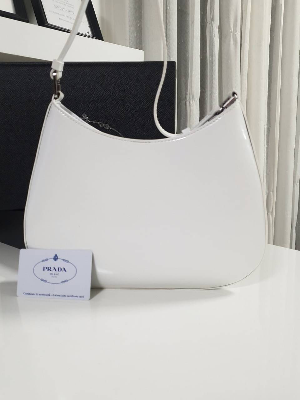 Prada Cleo brushed leather shoulder bag กระเป๋าทรงสวยยอดฮิต กับแบรนด์ PRADA งานพรีเมียมกิ้ฟท์จากแบรนด์ ทรงสะพายไหล่สวยหรูอยู่ทรง PRADA CLEO หนังเรียบดำเงาหรูสุดคลาสสิต เปิดปิดด้วยกระดุมอะไหล่เงินทั้งใบ ด้านในใส่กระเป๋าสตางค์ยาว มือถือ ของจุกจิกได้เยอะ มีป