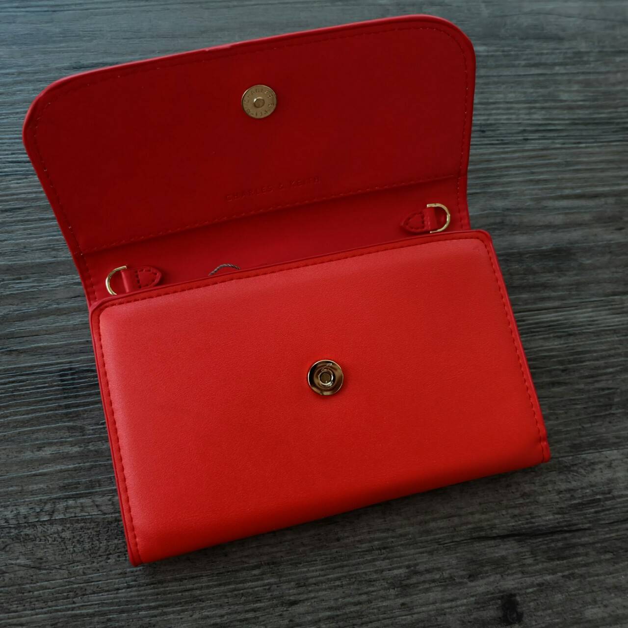 CHARLES&KEITH FRONT FLAP WALLET กระเป๋าสตางค์แบบ cluth คลัช รุ่นชนช็อปเปิดปิดด้วยฝาปิดกระดุมแม่เหล็ก ด้านหน้ามีโลโก้แบรนด์ ภายในมีช่องใส่ของ เยอะค่ะ มีทั้งฝช่องซิป และช่องใส่บัตรหลายช่อง สามารถใส่ธนบัตร มือถือ เหรียญและบัตรได้เยอะ มีกระดุมปรับขยายทรง มาพร