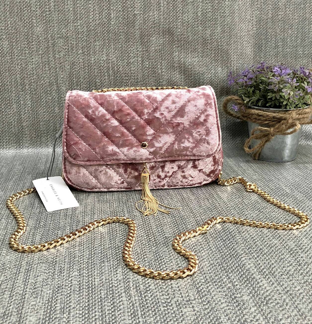 CHARLES & KEITH TASSEL DETAIL SHOULDER BAG กระเป๋าสะพายข้าง ทรงน่ารัก ด้านหน้ามีพู่ห้อย เปิดปิดกระเป๋าแบบแม่เหล็ก ด้านในโล่ง มีช่องซิป 1 ช่อง และช่องใส่บัตรได้ 3 ช่องค่ะ สายสะพายโซ่สีทองหรูหราค่ะ