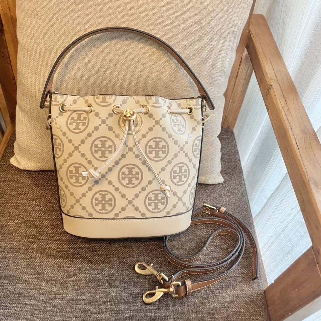 Medium : Tory Burch T Monogram Embossed Bucket Bag กระเป๋าถือหรือสะพายไหล่ ประดับด้วยลวดลายอันเป็นสัญลักษณ์ของแบรนด์ ถูกประดิษขึ้นด้วยความพิถีพิถันวัสดุหนังอย่างดี ด้านในบุด้วยหนังไมโครซูแอคเนื้อนุ่มทำความสะอาดง่าย กระเป๋าผ่าหลังด้านนอก1ช่อง ด้านใน 1ช่อง 