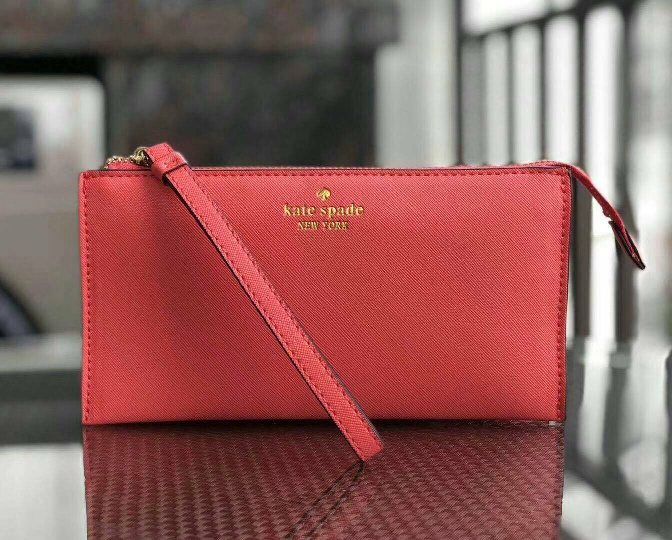KATE SPADE Wallet Clutch Bag กระเป๋าทรงคลัชสุดคุ้มหนัง Saffiano ด้านหน้ามีโลโก้แบรนด์ มาพร้อมสายคล้องมือ เปิดปิดด้วยซิปสะดวกใช้ สามารถใส่แทนกระเป๋าสตางค์ใบยาว ภายในแบ่งออกเป็น3ช่องหลัก มีช่องใส่บัตร เครื่องสำอาง เครื่องเขียน เหรียญ ไส่ไอโฟนพลัส ได้ค่ะ มีก