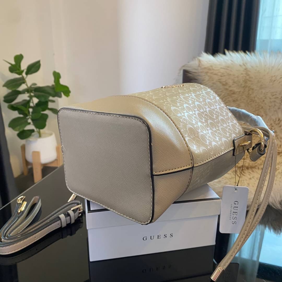 Guess Agata Bucket Handbag กระเป๋ารุ่นใหม่ล่าสุดทรงถังสุดน่ารัก พิมพ์ลายรอบใบ วัสดุ Saffiano PU คุณภาพดี นิ่ม น้ำหนักเบา ด้านหน้าประดับด้วยโลโก้แบรนด์สวยโดดเด่น เปิด-ปิดด้วยเชือกหนังใช้หูรูดปลายเชือกประดับอะไหล่ทองสะดวกใช้ ด้านในโล่งกว้างมีช่องเล็กสำหรับใ