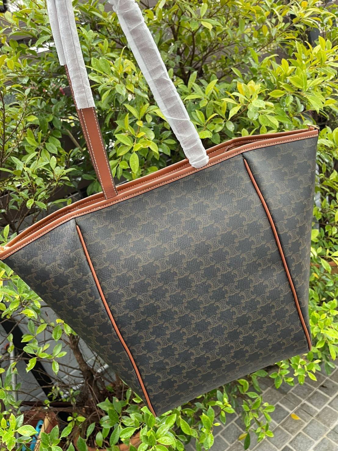 Celine Medium shopping bag in Triomphe canvas มาในรูปแบบ กระเป๋า Shopping Bag ใบสวยสง่า เป็นกระเป๋าดีไซน์เรียบง่าย แมตช์ได้กับทุกชุด ผลิตจากผ้าแคนวาสชนิดพิเศษซึ่งโดดเด่นด้วยลายเอกลักษณ์ของ Triompe เป็นใบที่เหมาะกับการใช้ประจำวันเป็นอย่างมาก ด้วยรูปทรงสี่เ