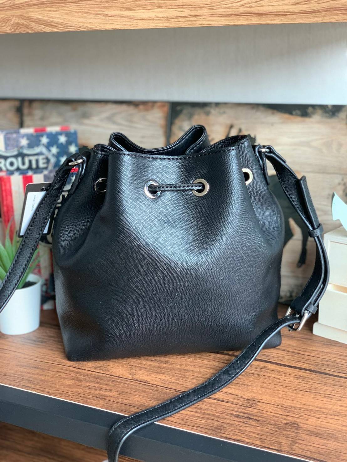 Guess Drawstring Bucket Bag กระเป๋าสะพายขนาดกลาง วัสดุลายหนังsaffiano ฐานกว้างตั้งอยู่ทรง มีซิกเนเจอร์ที่ด้านหน้าเป็นโลโก้ตัวนูน เปิดปิดแบบหูรูดและกระดุมแม่เหล็ก มีช่องใช้งานหลายข่อง สายสะพายปรับได้แบบเข็มขัด สวยแบบมีดีเทลเก๋ๆ สะพายเที่ยวระหว่างวันได้สบาย