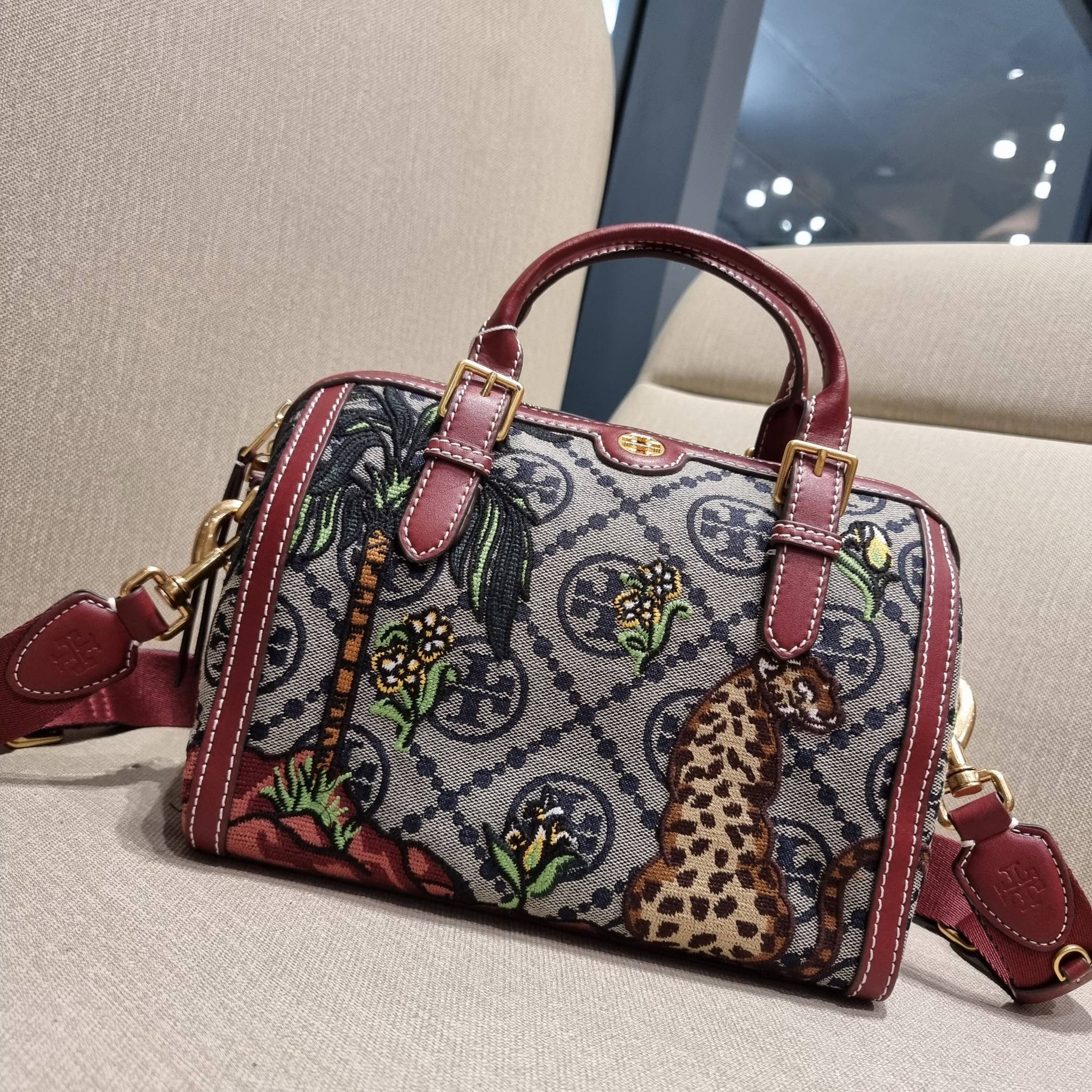 TORY BURCH T MONOGRAM JACQUARD EMBROIDERED DUFFLE คอลใหม่ล่าสุด สวยพร้อมเสิร์ฟแบบไม่ต้องรอพรีฯ ลายโมโนแกรมสุดคลาสสิคที่ถูกดีไซน์รังสรรค์ด้วยงานปักสุดชิค น่าใช้ใจฟูแค่แรกเห็น!! วัสดุ jacquard woven สลับหนังแท้ หูจับในตัว และพร้อมไปเลยกับสายสะพายข้าง ที่จะถ