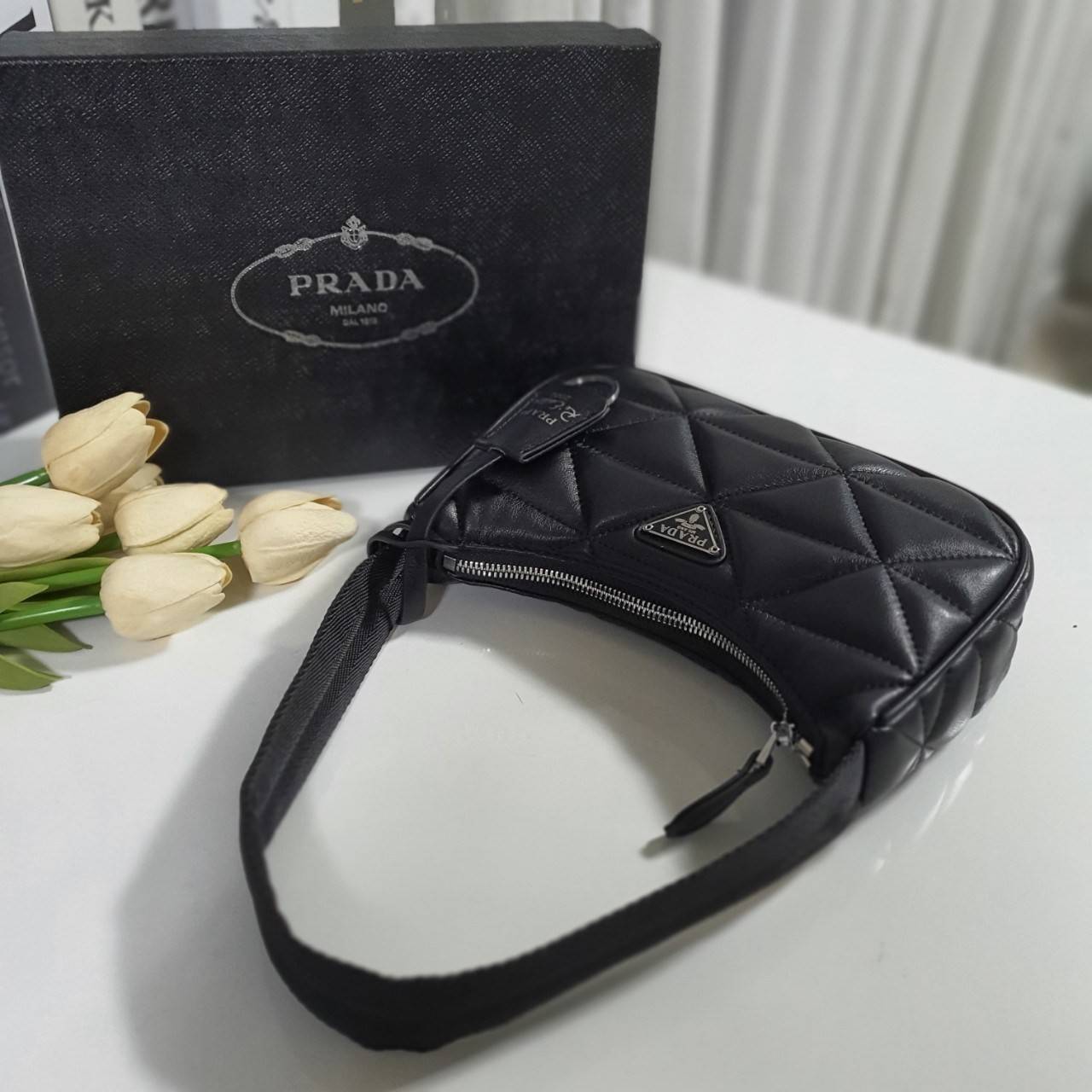 รุ่นใหม่แนะนำ!! กับงานพรีเมี่ยมกิ้ฟท์ PRADA HANDBAGS ขนาดกะทัดรัด **อะไหล่เงิน วัสดุทำจากหนัง Pu อย่างหนาลายตารางสวยหรูดูดี อยู่ทรง กันน้ำได้ หายห่วงคะ ด้านหน้ามีโลโก้แบรนด์ เปิดปิดด้วยซิป มาพร้อมสายผ้า ไม่สามารถถอดได้ ภายในบุผ้าลายPrada และป้ายโลหะแบรนด์