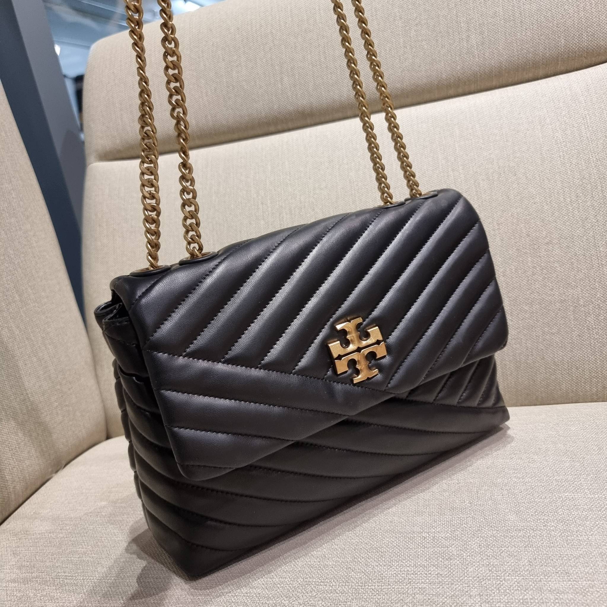 TORY BURCH KIRA CHEVRON CONVERTIBLE SHOULDER BAG กระเป๋าสะพายรุ่นยอดฮิต ไซส์ใหญ่จัดเต็มให้เน้นๆ ใช้ยังไงก็ดูหรู ดีไซน์เฉพาะตัว วัสดุหนังแกะ สัมผัสนิ่ม เปิด-ปิดด้วยกระดุมแม่เหล็ก ภายในเป็นช่องโล่ง แบ่งสัดส่วนไว้ดีมากๆ ใส่กระเป๋าสตางค์ มือถือ เครื่องสำอางค์