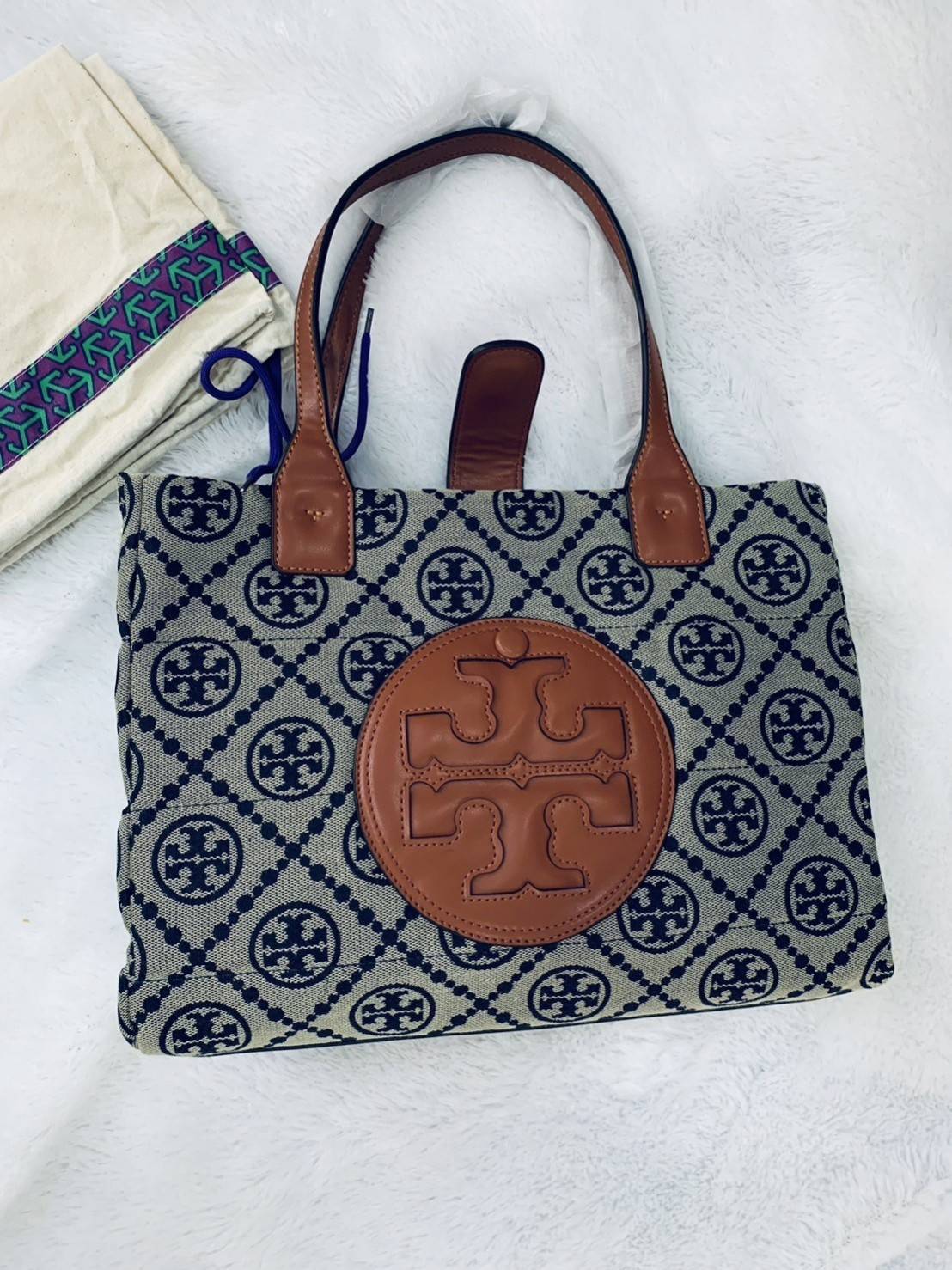TORY BURCH MONOGRAM TOTE BAG กระเป๋าที่มีเอกลักษณ์เฉพาะตัว วัสดุผ้าแคนวาส Canvas ลวดลายโมโนแกรม เนื้อผ้าหนาสัมผัสนุ่ม โครงสร้างกระเป๋าวัสดุแข็งแรง