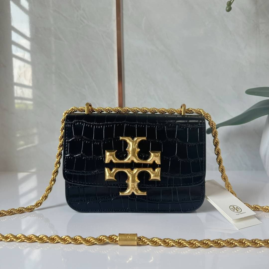 6 สี Tory Burch Croc Eleanor Small Bag / TORY BURCH ELEANOR CROC EMBOSSED LEATHER กระเป๋าสะพายหนังพิมพ์ลายจระเข้ ดีไซน์หรูหรา โด่นเด่นด้วยโลโก้แบรนด์อะไหล่ด้านหน้า และสายสะพายโลหะสีทอง