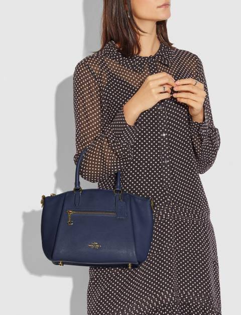 Coach Elise Satchel Polished pebble leather Inside zip and snap pockets Zip-top closure, fabric lining Handles