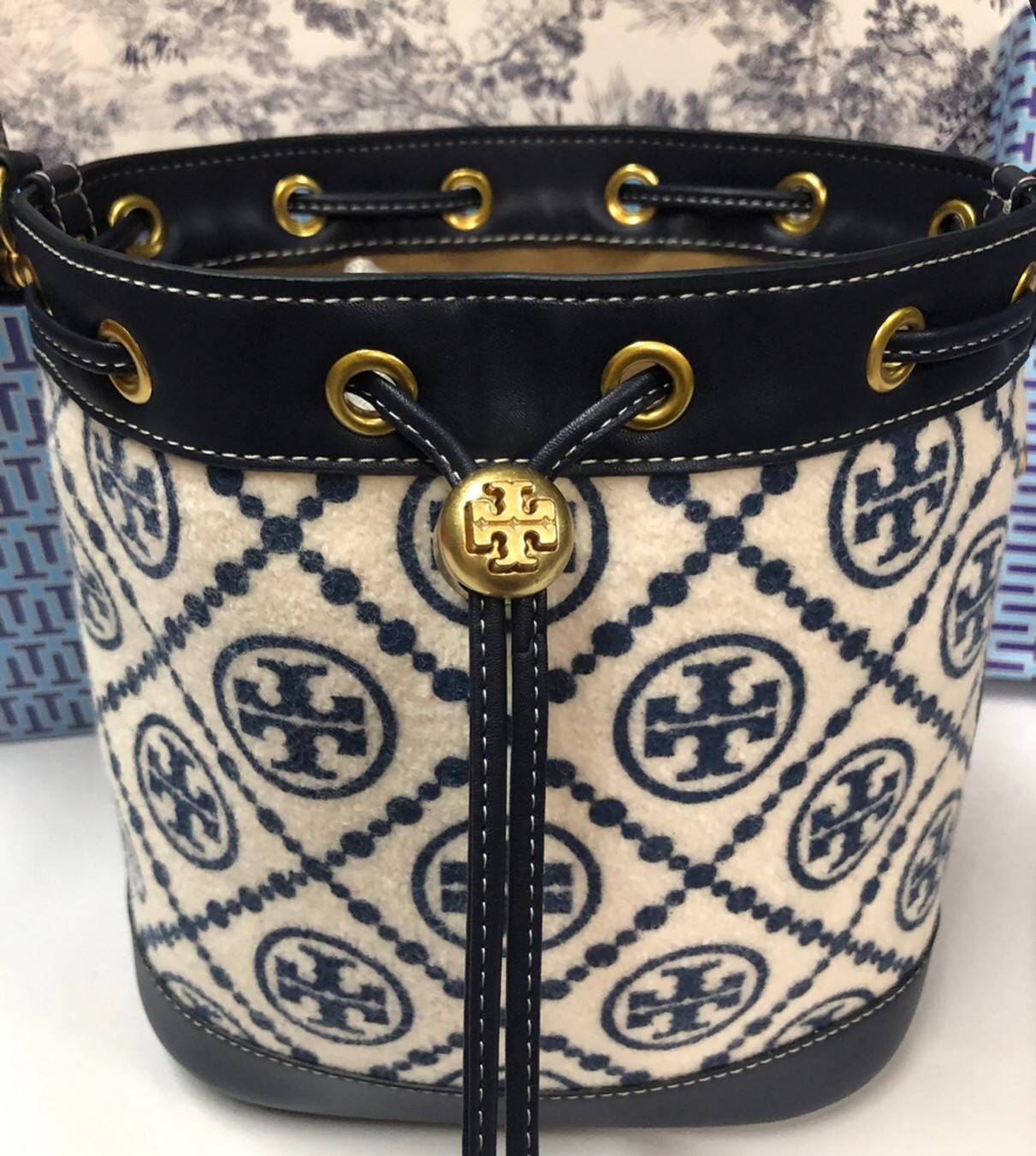 Medium : Tory Burch T Monogram Chenille Bucket Bag เปิดตัวอีกหนึ่งรุ่นกับกระเป๋าลาย T MONOGRAM รุ่นใหม่ล่าสุดจาก TORY BURCH พลาดไม่ได้กับโลโก้สุดคลาสสิก ลวดลาย T Monogram คือวัสดุ chenille หรือที่เรียกว่า ด้านไหมกำมะหยี่ มารังสรรค์ลงบนกระเป๋าBucketใบนี้ เ