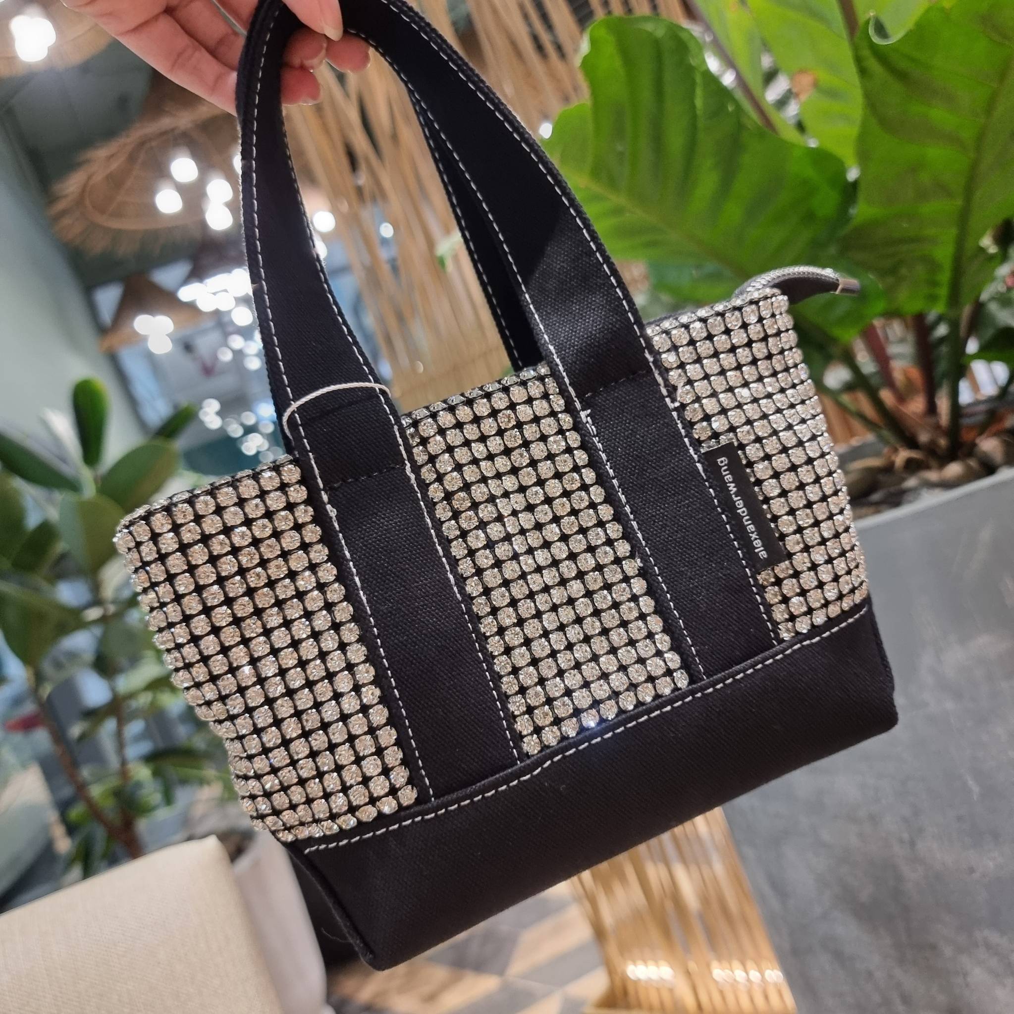 ALEXANDER WANG HANDBAG MINI TOTE WITH RHINESTONE กระเป๋าทรงมินิโท้ท น่ารักน่าเอ็นดู น่าใช้เหลือเกิน!! ด้วยความโดดเด่นเด่นของการตกแต่งพลอยเทียม ให้ดีเทลหรู ตัดสลับด้วยผ้าแคนวาส เพิ่มความทนทาน ลงตัวมากๆ และยังใช้งานง่ายด้วยหูจับในตัว เปิด-ปิดด้วยซิป ภายในเป