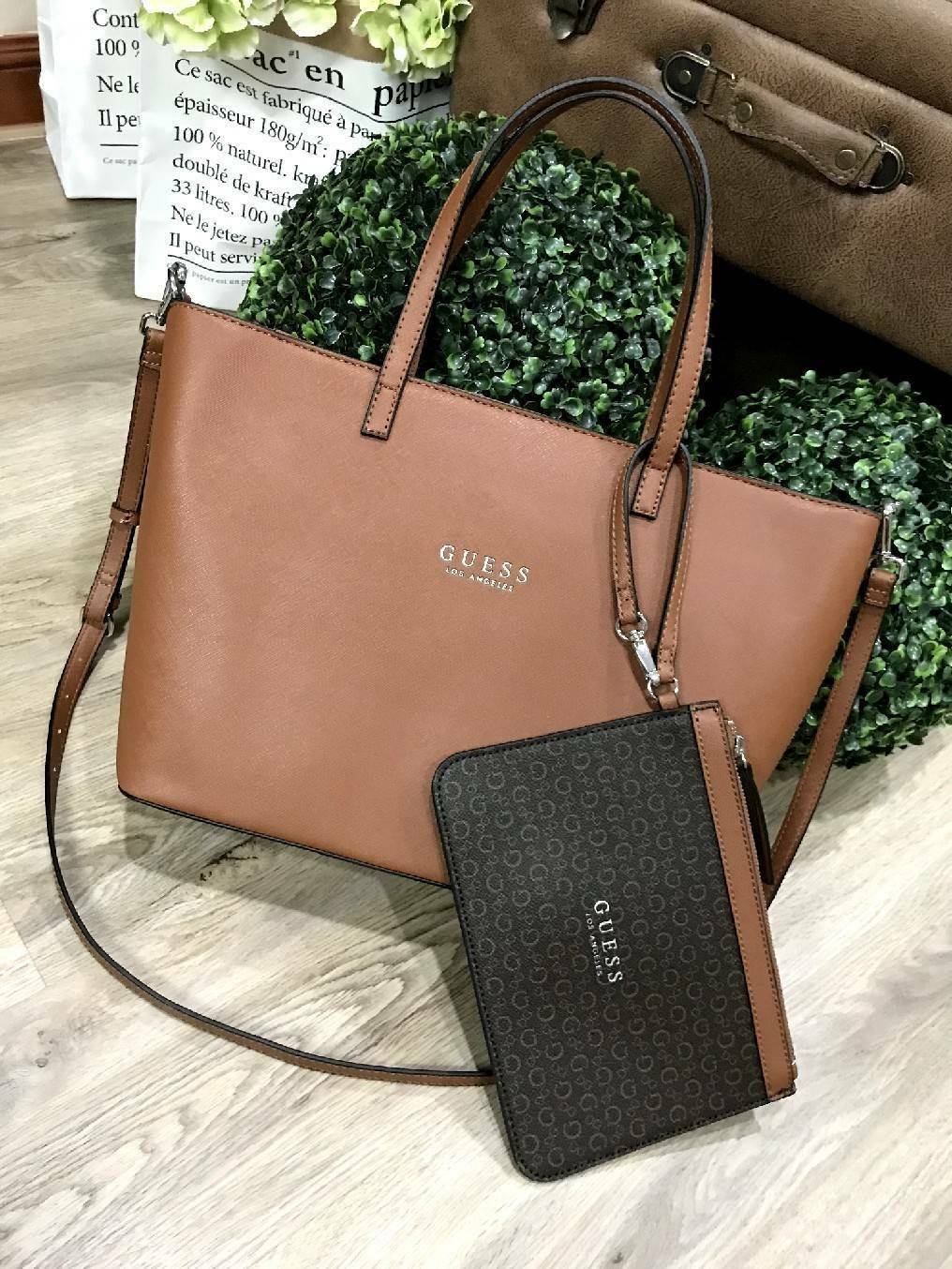 GUESS LARGE SHOPPER BAG WITH POUCH กระเป๋าสะพายรุ่นใหม่ล่าสุดจาก GUESS FACTORY หนัง Saffiano สวยหรูอยู่ทรง ด้านหน้ามีโลโก้แบรนด์ ด้านหลังมีช่องใส่ของ หูหิ้วสะพายไหล่ได้มาพร้อมสายสะพายยาวถอดได้ปรับได้ มีกระเป๋าใบเล็กเข้าชุดกันห้อยที่หูหิ้ว ใบเล็กถอดเเยกใช้