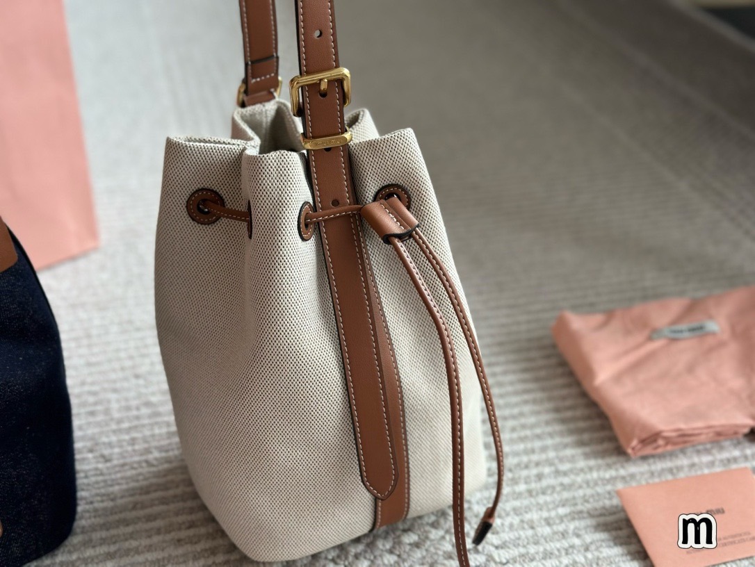 MIU MIU Canvas and leather bucket bag / MIU MIU Bucket Bag กระเป๋าทรงบัคเก็ต ผ้าแคนวาสอย่างดีตกแต่งโลโก้เพิ่มสัมผัสอันเป็นเอกลักษณ์