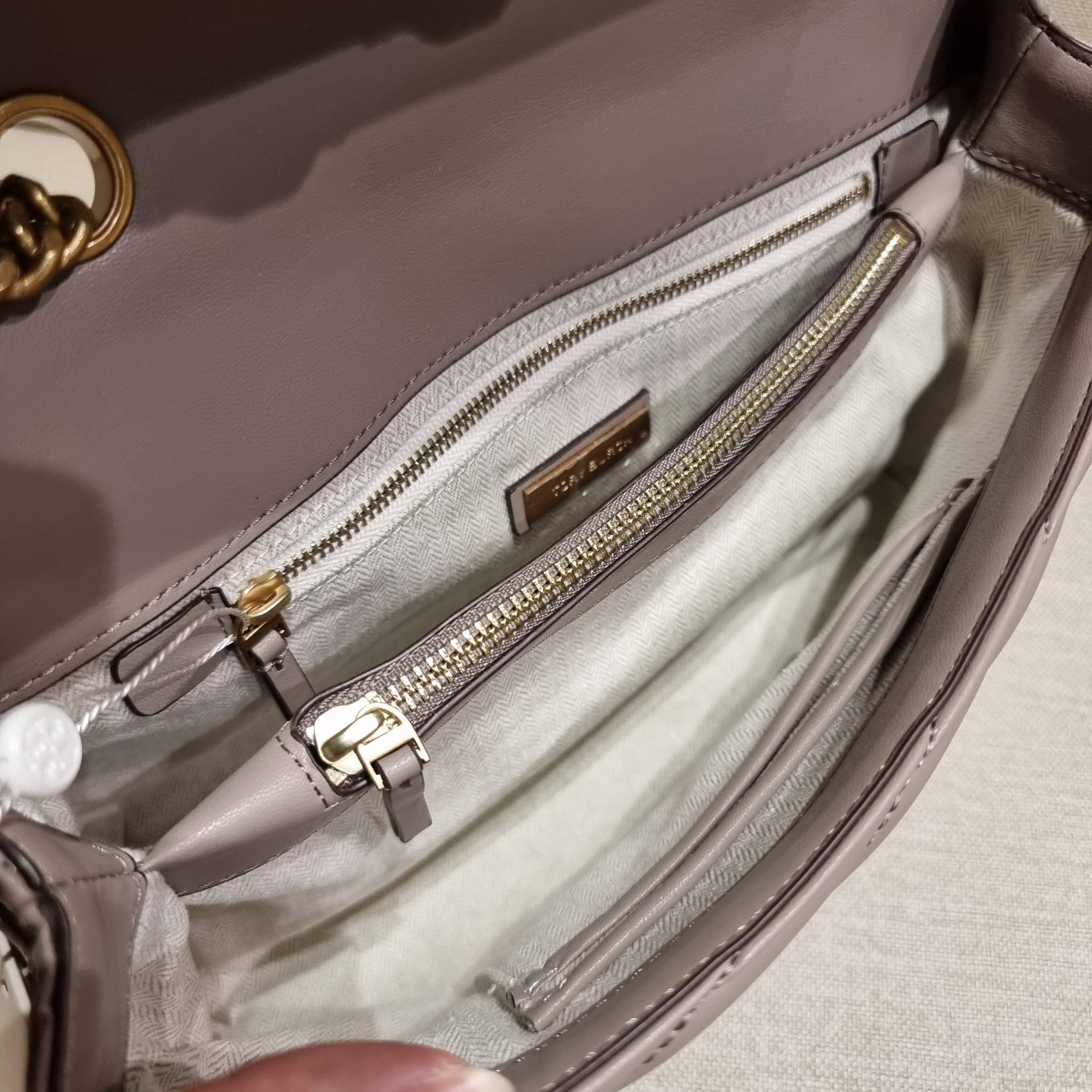 TORY BURCH KIRA CHEVRON CONVERTIBLE SHOULDER BAG กระเป๋าสะพายรุ่นยอดฮิต ไซส์ใหญ่จัดเต็มให้เน้นๆ ใช้ยังไงก็ดูหรู ดีไซน์เฉพาะตัว วัสดุหนังแกะ สัมผัสนิ่ม เปิด-ปิดด้วยกระดุมแม่เหล็ก ภายในเป็นช่องโล่ง แบ่งสัดส่วนไว้ดีมากๆ ใส่กระเป๋าสตางค์ มือถือ เครื่องสำอางค์