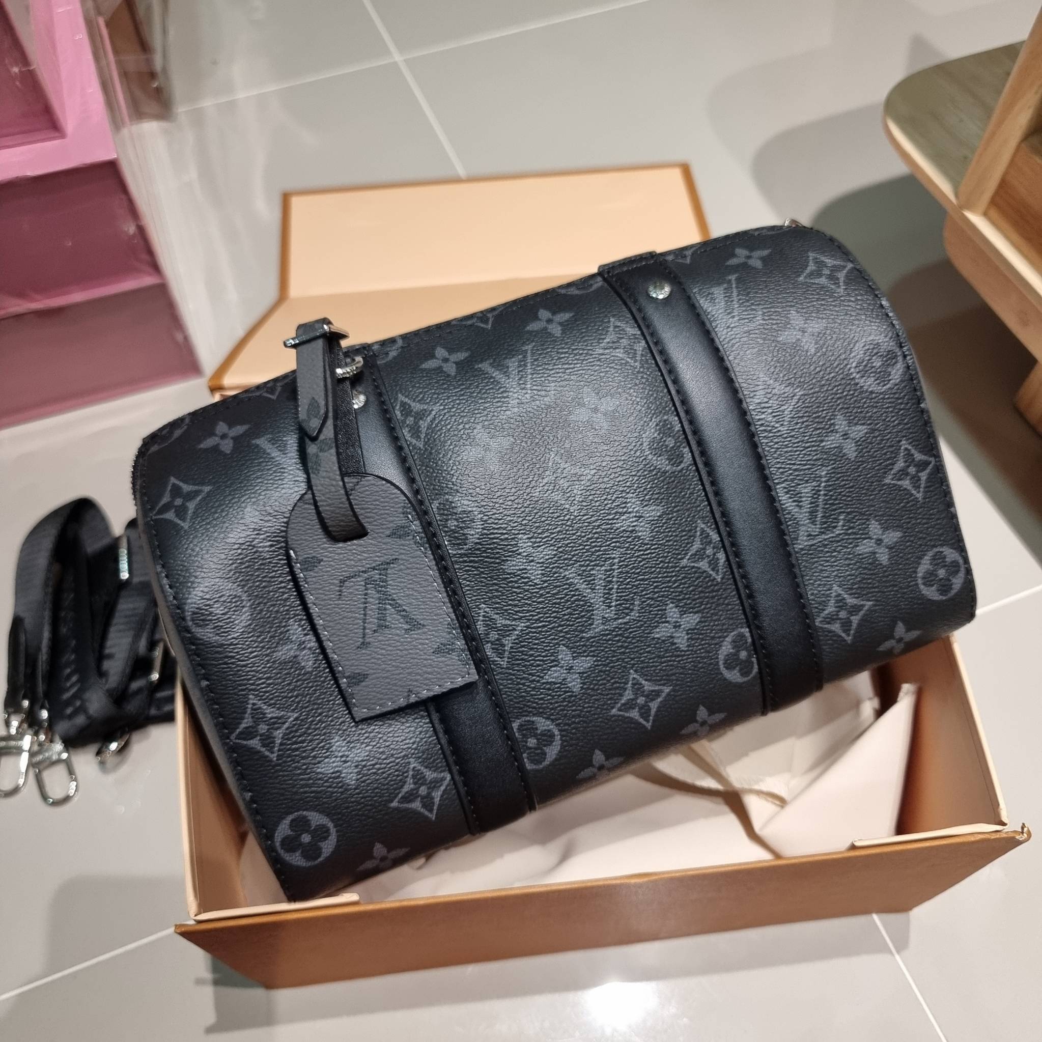 LV CITY KEEPALL Monogram Eclipse Bag กระเป๋าสะพายทรงหมอนสุดคลาสสิค ด้วยดีเทลความเป็นเอกลักษณ์ เรียบหรูด้วยความโดดเด่นจากลวดลายโมโนแกรม ขนาดกำลังดี