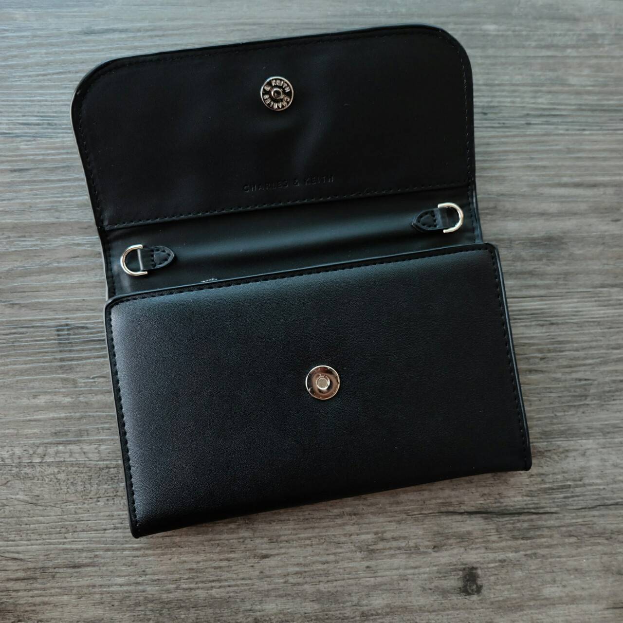 CHARLES&KEITH FRONT FLAP WALLET กระเป๋าสตางค์แบบ cluth คลัช รุ่นชนช็อปเปิดปิดด้วยฝาปิดกระดุมแม่เหล็ก ด้านหน้ามีโลโก้แบรนด์ ภายในมีช่องใส่ของ เยอะค่ะ มีทั้งฝช่องซิป และช่องใส่บัตรหลายช่อง สามารถใส่ธนบัตร มือถือ เหรียญและบัตรได้เยอะ มีกระดุมปรับขยายทรง มาพร