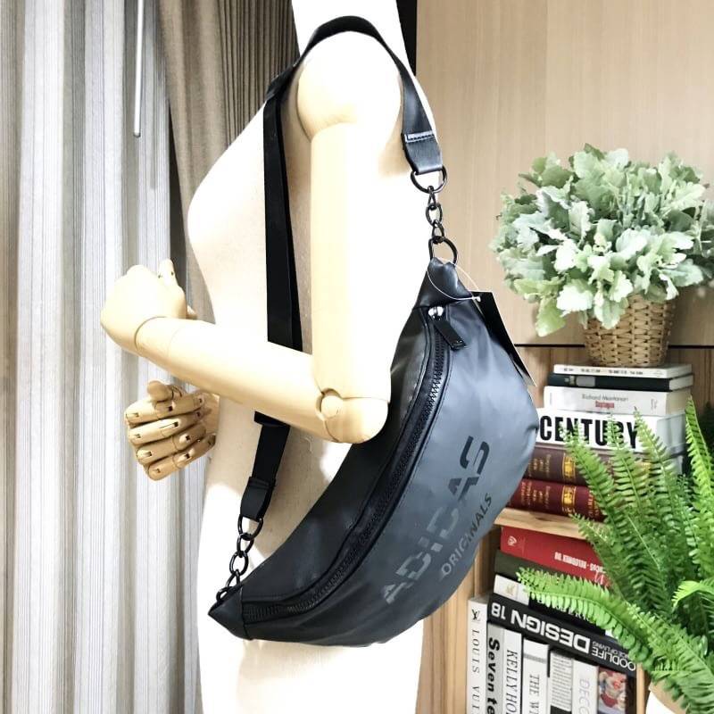 Adidas Waist Bag กระเป๋าสะพายสไตล์สปอร์ตแบบคาดเอวหรือคาดอกดีไซน์สุดฮิตใช้ได้ทั้งชายและหญิง วัสดุไนล่อนเนื้อแมทแบบนิ่มด้านหลังเป็นหนังเรียบ กันน้ำทำความสะอาดง่าย ขนาดกำลังดี น้ำหนักเบา ด้านหน้ามีโลโก้แบรนด์ เปิดปิดด้วยซิปสะดวกใช้ หัวซิปแบรนด์ สายสะพายเลื่อ