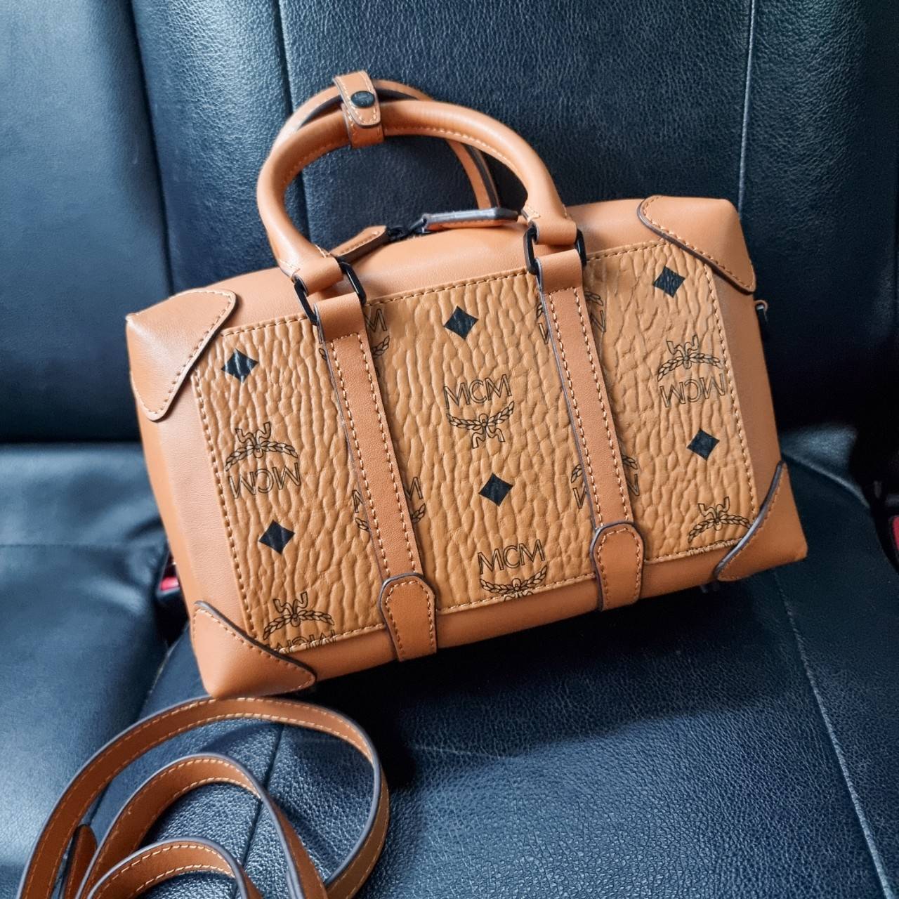 M.C.M SMALL E/W SOFT BERLIN CROSSBODY IN VISETOS ไอเท็มใหม่ในดีไซน์ทรงกระเป๋าเดินทางแบบคลาสสิค ย่อส่วนมาให้ใช้งานได้แบบสบายๆ พกพาสะดวก แมทช์ได้ทุกสไตล์ ใช้ได้แบบ unisex ใช้งานง่ายด้วยหูจับในตัว และซิปหลัก อะไหล่สีดำดูมีมิติตัดกับสีน้ำตาลคอนยัคได้เป็นอย่าง