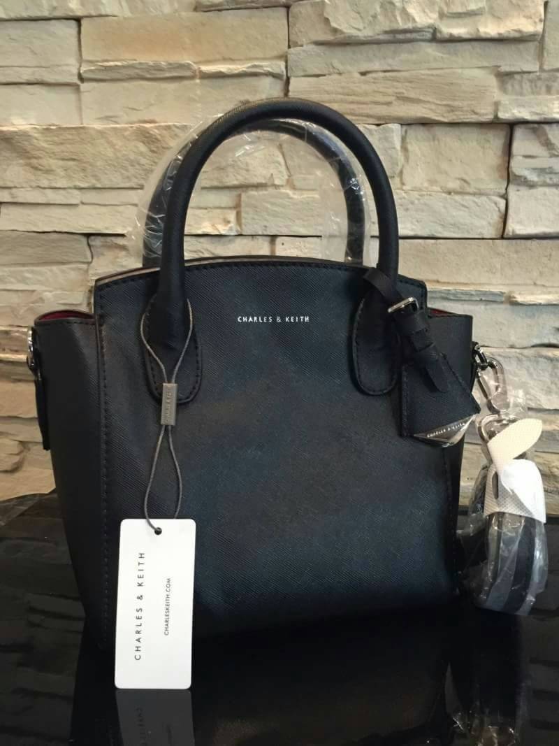 CHARLES & KEITH GUSSETED TOTE BAG กระเป๋าถือหรือสะพายวัสดุหนัง Saffiano สวยอยู่ทรงเเข็ง ไม่ย้วย ขนาดกำลังดี น้ำหนักเบา ดีไซน์สวยเก๋ด้วย TAG .ห้อยที่หูกระเป๋าปั๊มโลโก้แบรนด์อะไหล่ถอดเเยกใช้ได้ เปิดปิดด้วยซิปสะดวกใช้ สามารถใส่กระเป๋าสตางค์ใบยาว ของใช้จุกจิก