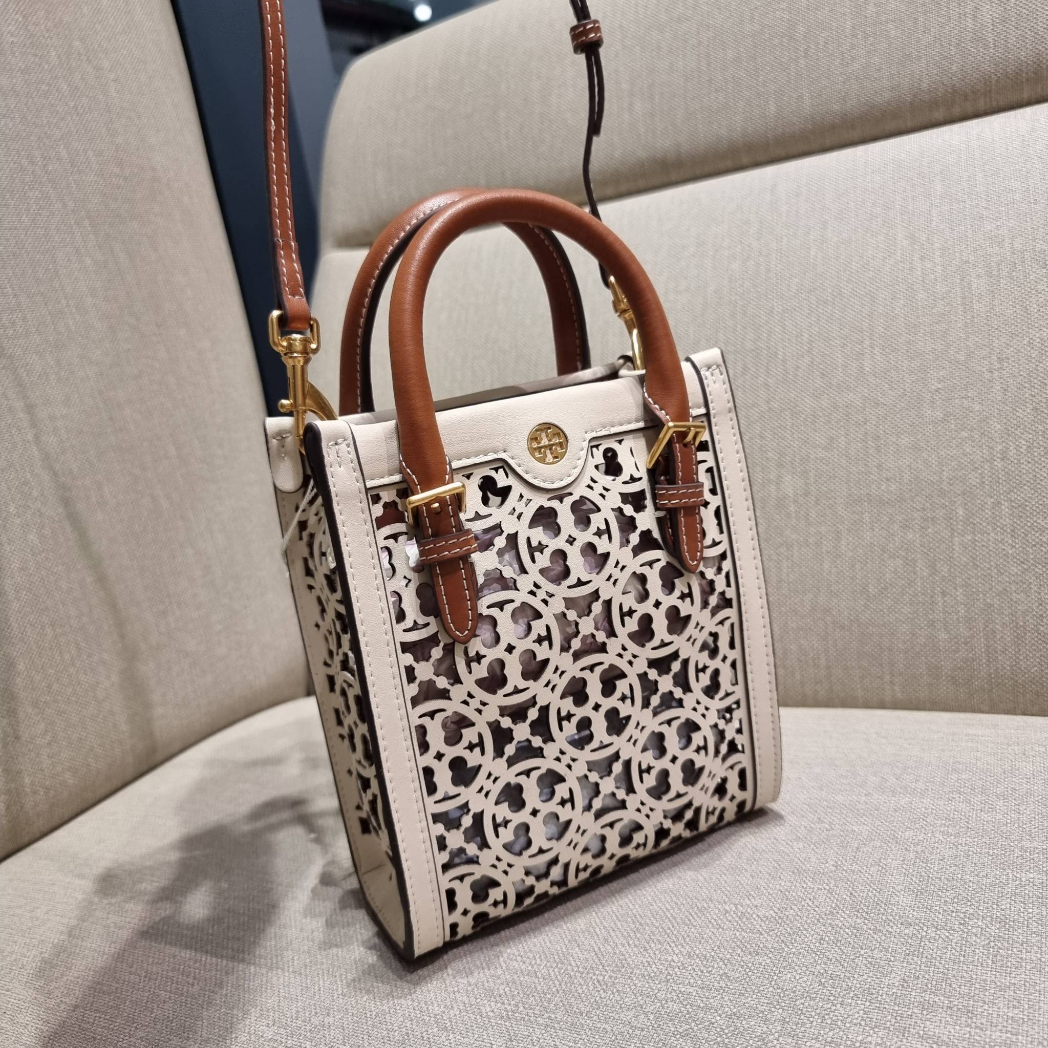 TORY BURCH T MONOGRAM LASER-CUT MINI TOTE ใจบางที่สุดกับคอลเลคชั่นนี้ กับกระเป๋าสะพายทรงโท้ท ไซส์มินิ ที่เพิ่มดีเทลความแพงด้วยการฉลุลวดลายโมโนแกรมรอบใบ ถักทอเป็นเส้นลายสานที่สวยงามมาก งานฝีมือจริงๆ วัสดุหนัง cowhide ปากกระเป๋ามีแถบแม่เหล็กกันหล่น และมีหูจ