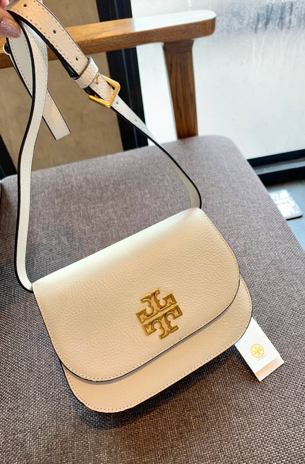 TORY BURCH BRLTTEN SMALL SADDLE BAG / Tory Burch Britten Flap Shoulder Bag กระเป๋าสะพายข้าง วัสดุหนังแกะแท้ ด้านหน้าประดับโลโก้แบรนด์ เปิด-ปิดกระเป๋าแบบกระดุมแป็กแม่เหล็กแน่นหนา ภายในมีช่องหลัก ใส่กระเป๋าเงินใบกลาง มือถือได้ทุกรุ่น มีช่องแยกใส่ของจุกจิกอี