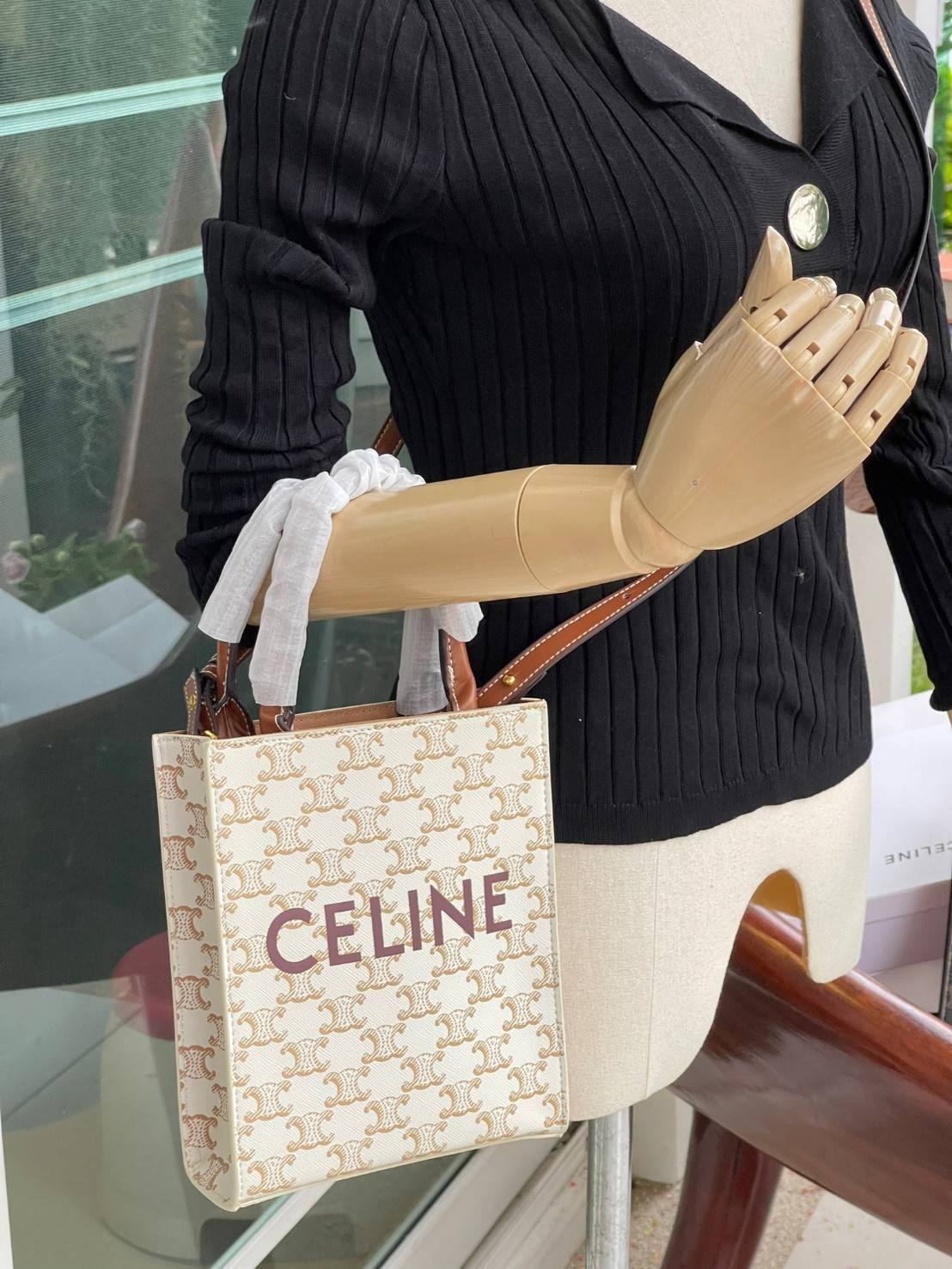 CELINE MINI VERTICAL CABAS IN TRIOMPHE CANVAS มีโลโก้ CELINE สกรีนอยู่ตรงกลาง ถือเป็นกระเป๋า Tote ที่ทำจากแคนวาสที่น่าสนใจมาก ๆ อีกรุ่นหนึ่ง และเป็นรุ่นที่ได้รับคำชื่นชมจากแฟชั่นกูรูทั้งหลายอีกด้วย หากใครที่อยากเป็นเจ้าของกระเป๋า Tote จาก CELINE สักใบ รุ่